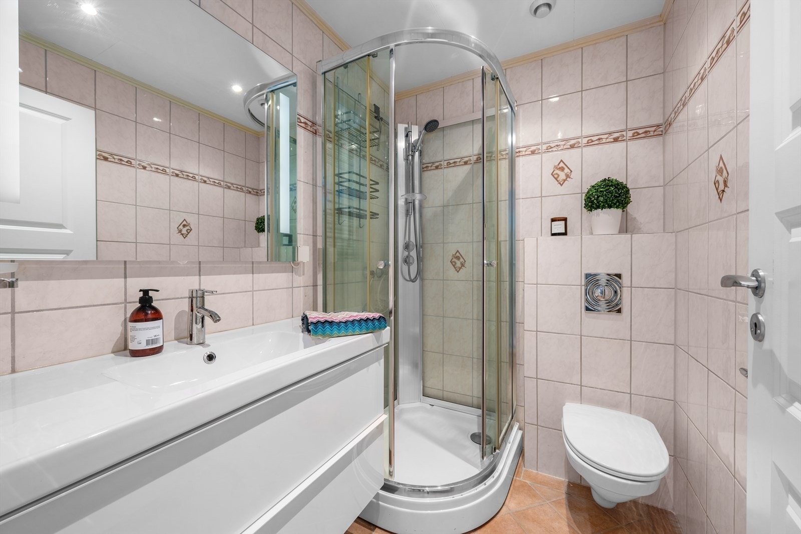 Boligen rommer tre bad. Det ene badet ligger i 1. etasjens hoveddel, og har servant med underskuffer, dusjkabinett og vegghengt toalett. Galleribilde