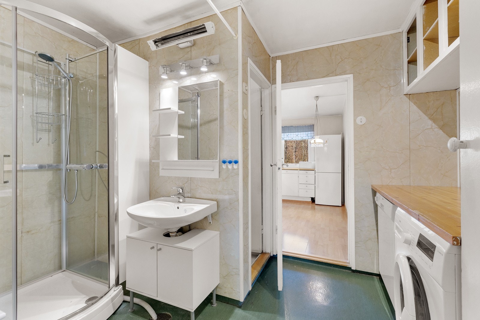 Baderommet er innredet med atskilt toalett, vask, speil over vask, naturlig plass til vaskemaskin og tørketrommel under benk og dusjkabinett Galleribilde