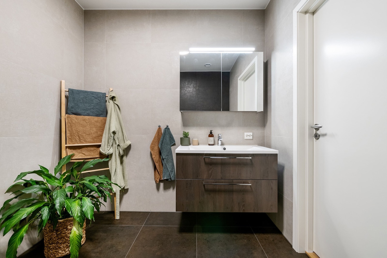 Servantinnredning med skuffer og speilskap med overlys på bad Galleribilde