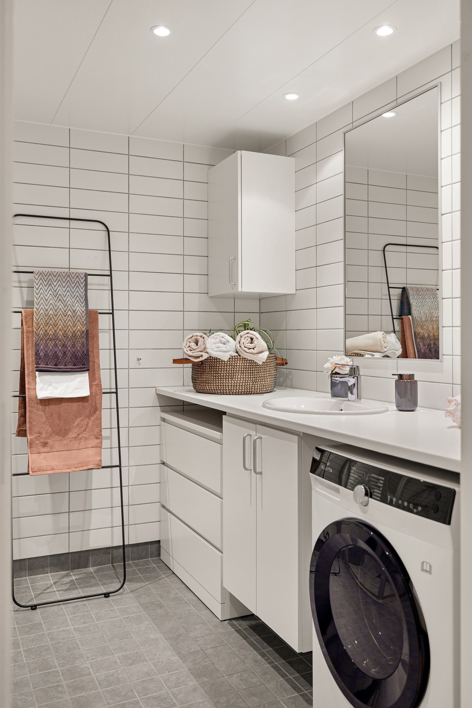 Lyst og delikat bad. Det er opplegg for vaskemaskin og tørketrommel. Galleribilde