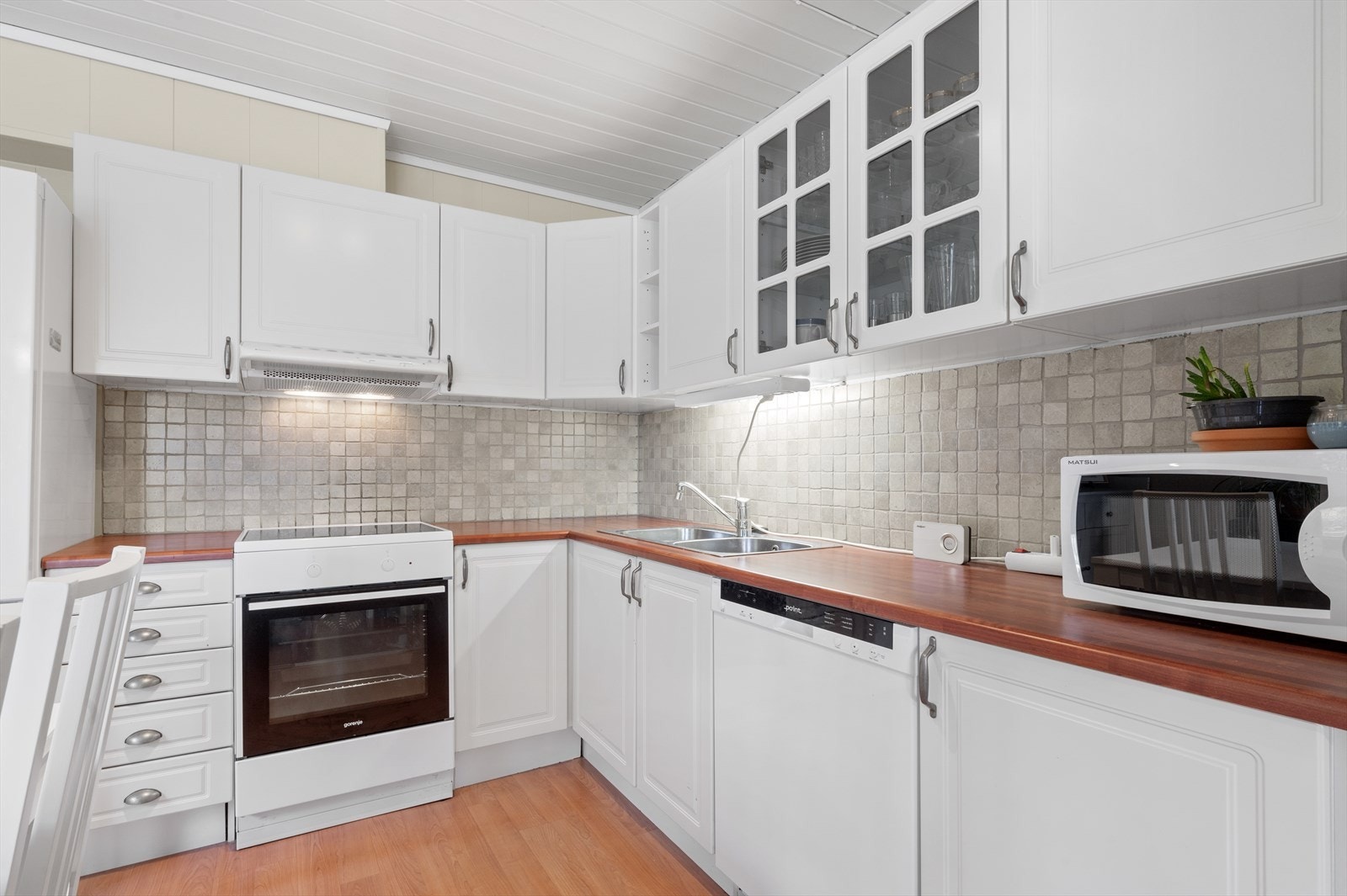 Pen kjøkkeninnredning med god skap- og benkeplass. Galleribilde