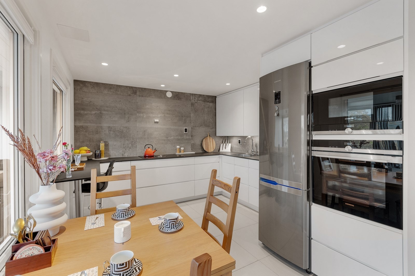 Kjøkkenet har innredning med glatte fronter. Benkeplaten er av laminat Galleribilde