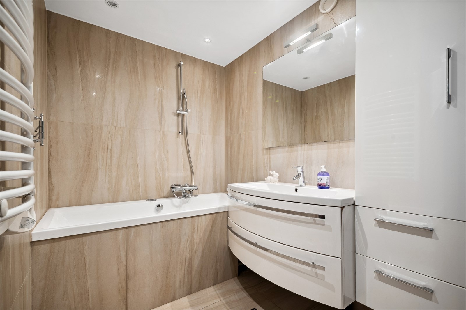 Flislagt bad med elektriske varmekabler, nedfelt servant, dusj/badekar og opplegg for vaskemaskin. Badet ble oppgradert i 2010. Galleribilde