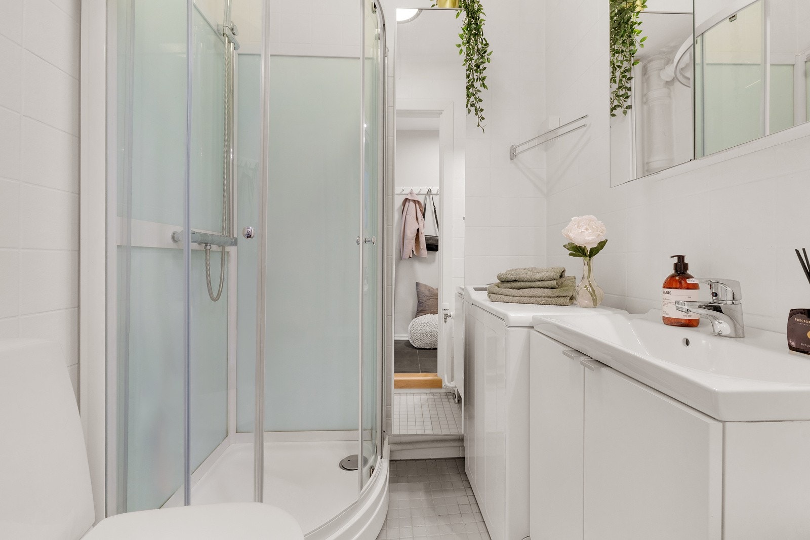 Bad med dusjkabinett, toalett og opplegg for vaskemaskin. Galleribilde