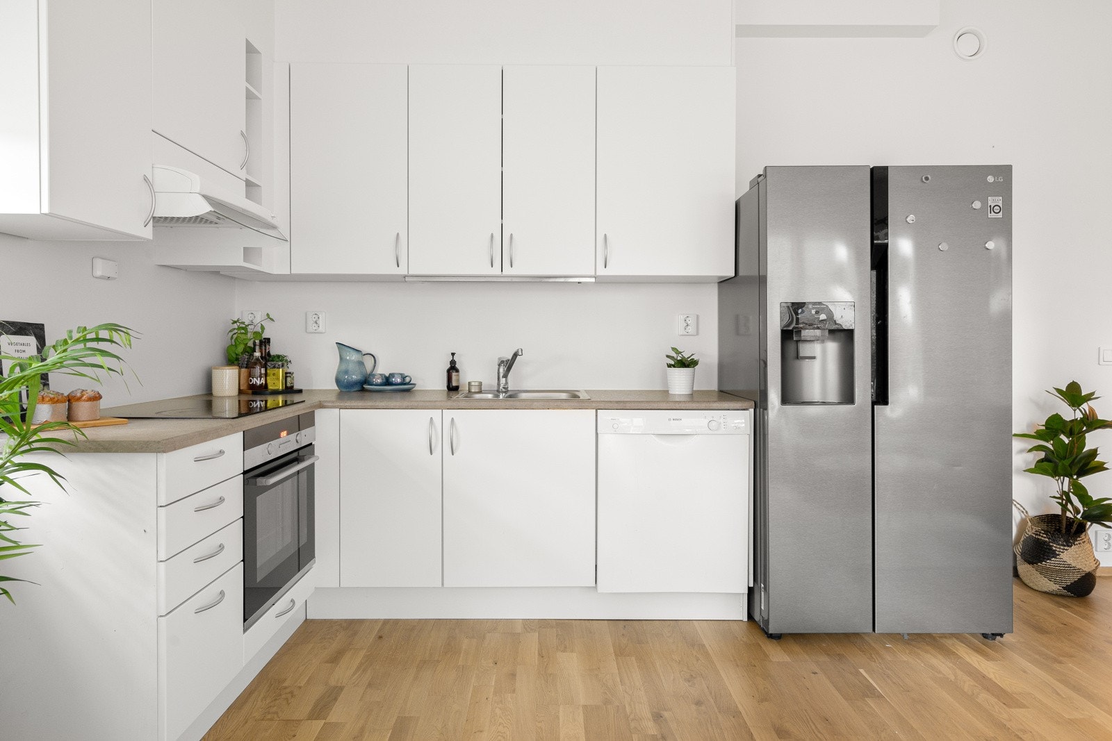 Moderne kjøkkeninnredning med glatte fronter og laminat benkeplater. Galleribilde
