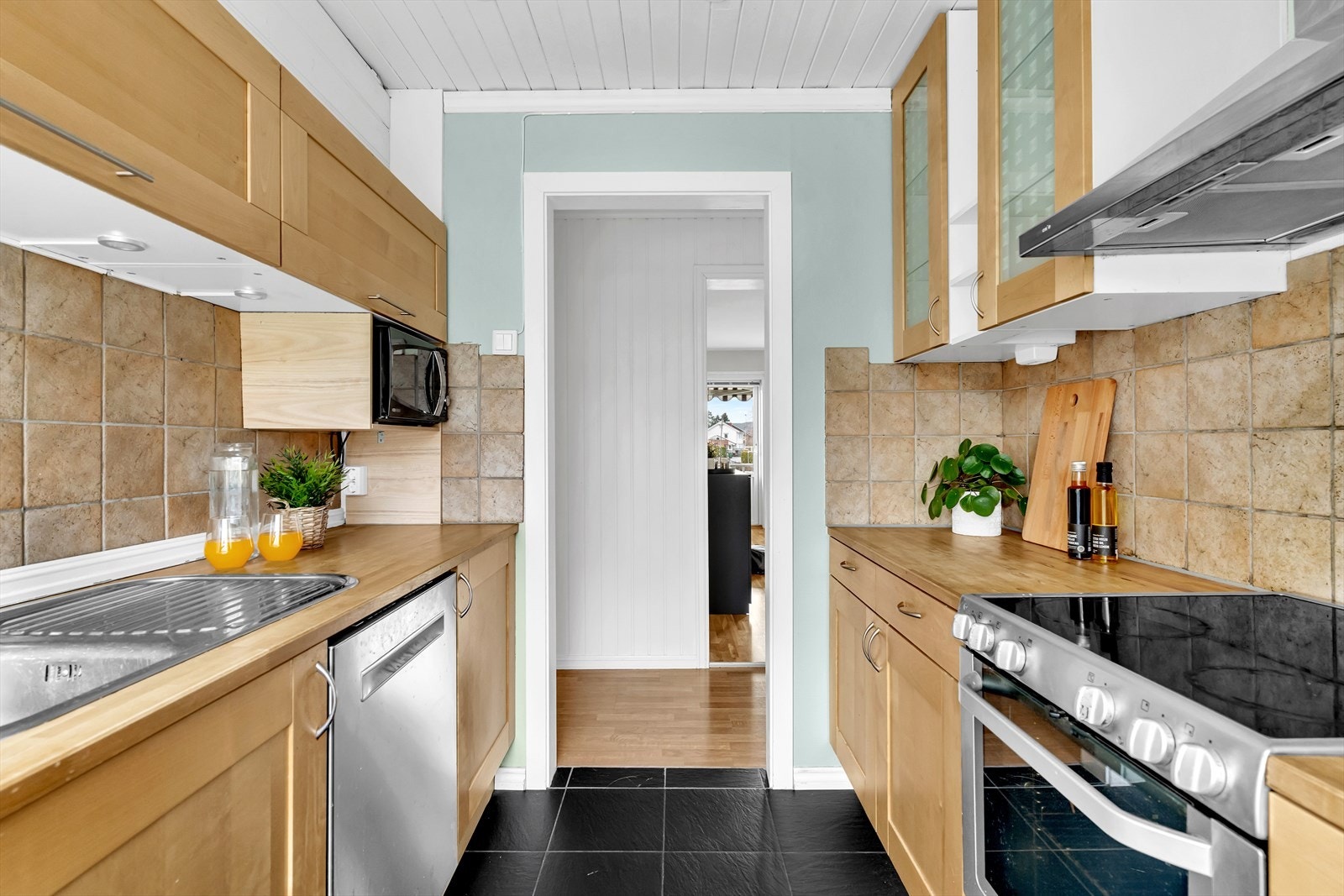 Mellom benkeplate og overskap er det fliser som går i ett med innredningen. Galleribilde