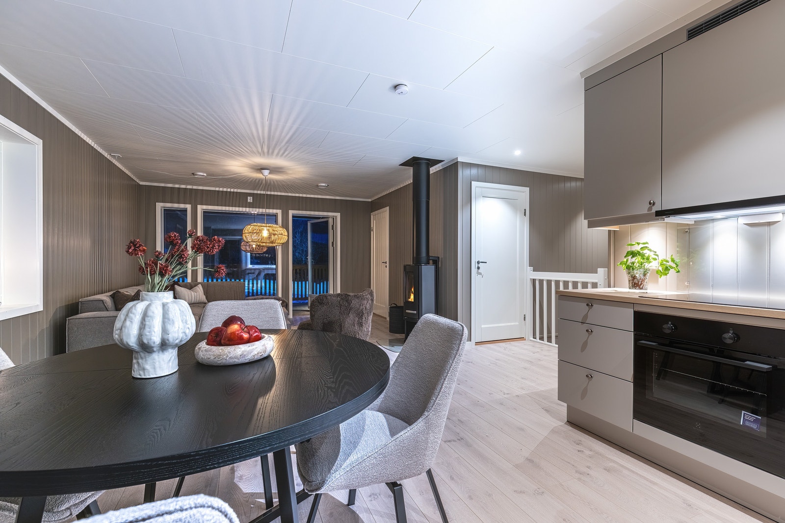 Romslig, åpen stue-/kjøkken løsning med vinduer og lysinnslipp fra tre kanter. Galleribilde