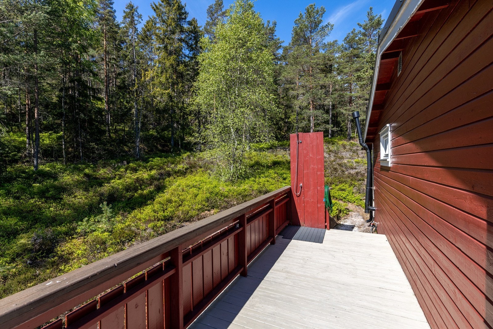 Balkongen strekker seg rundt to sider av hytta Galleribilde