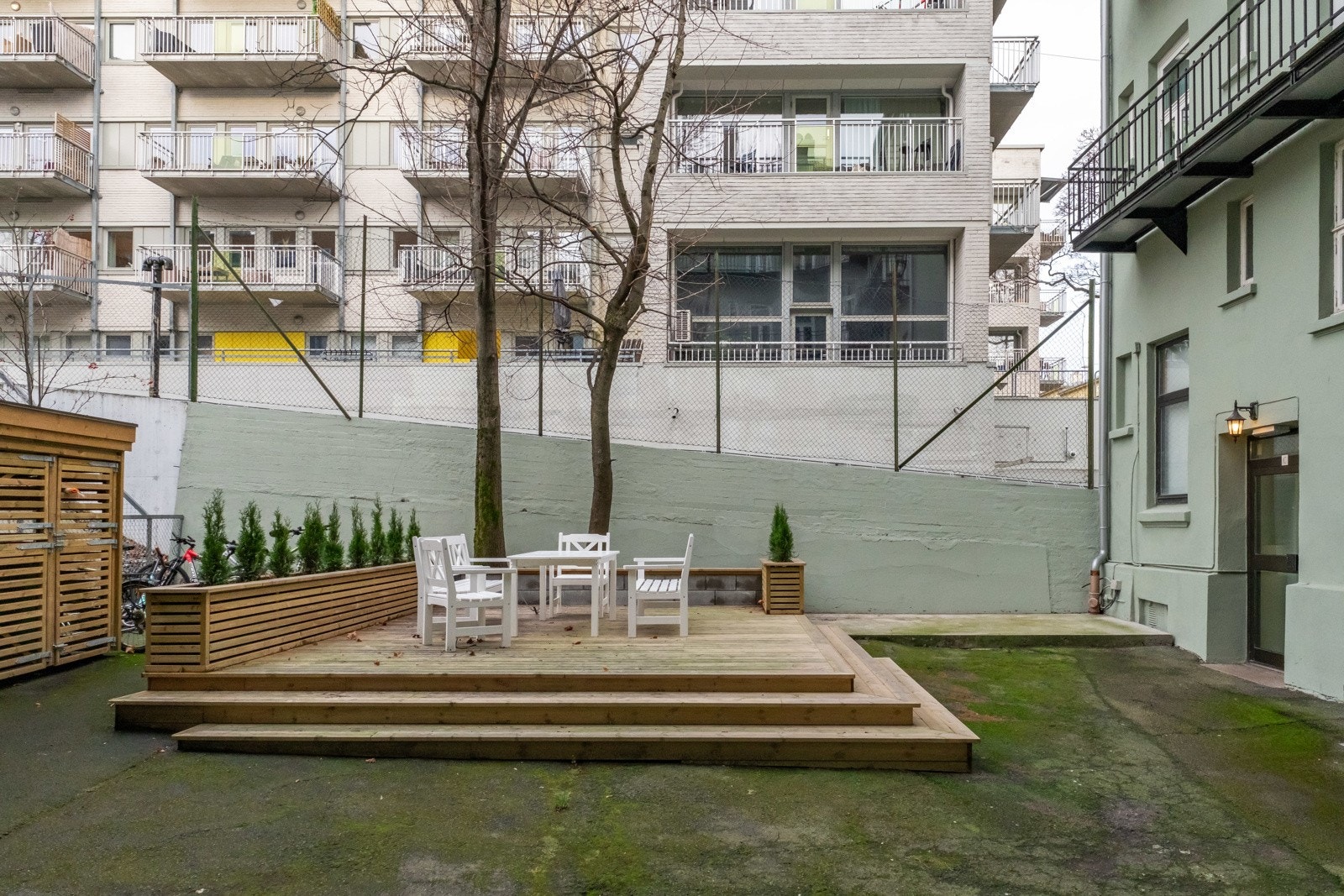 Bakgården er pent opparbeidet med platting, sittegrupper og sykkelparkering. Galleribilde