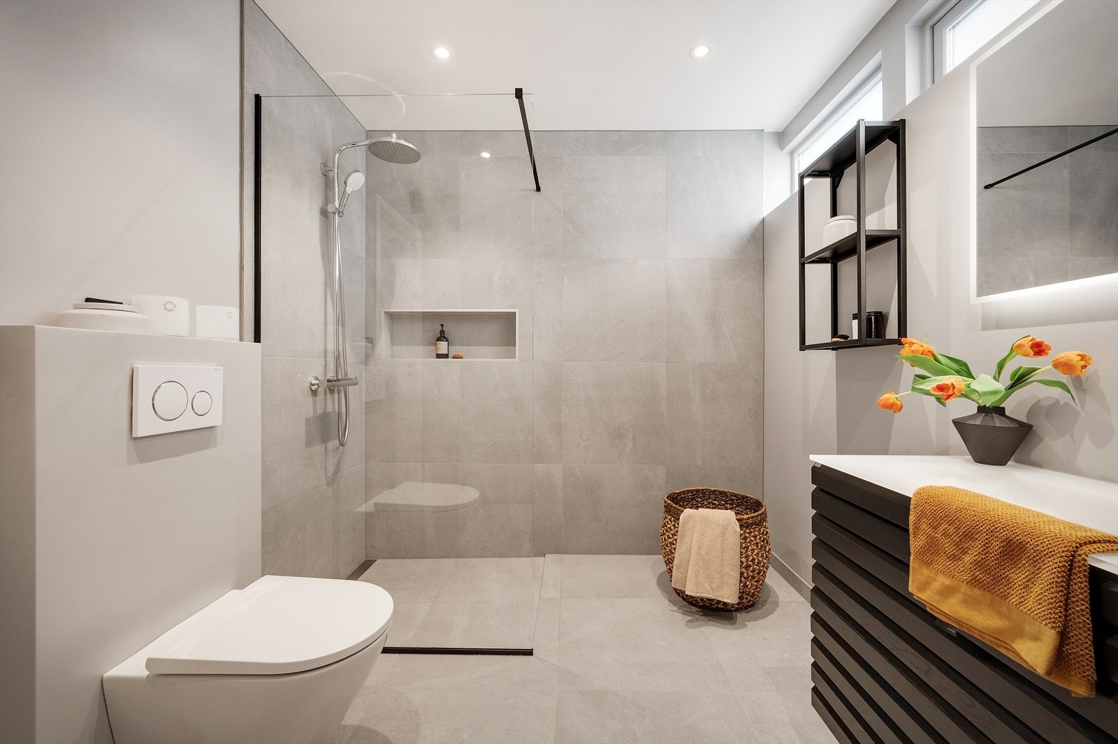 - Innredet med vegghengt toalett, benkeskap med servant, dusjnisje med glassvegg og speil med integrert belysning - Galleribilde