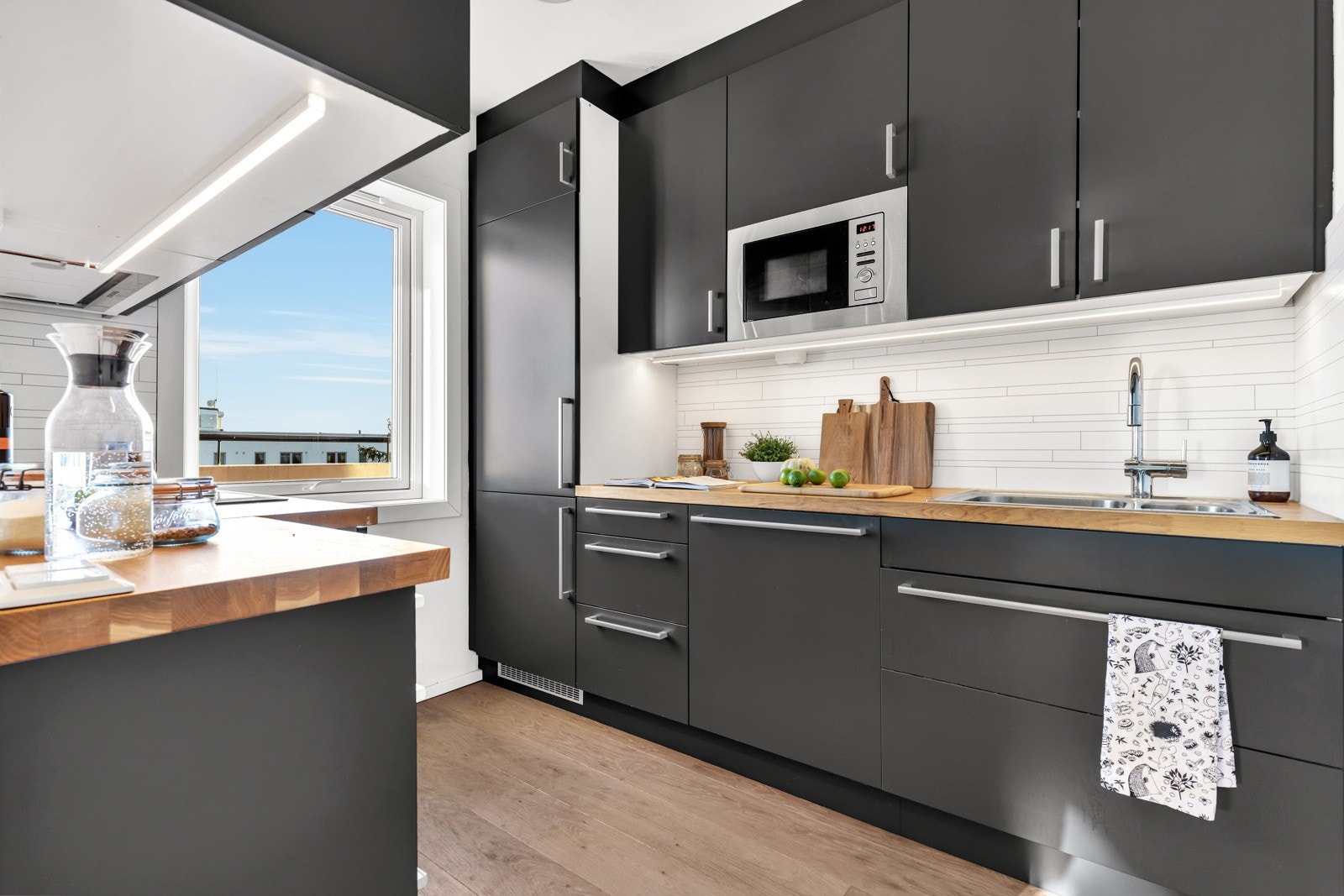 Praktisk kjøkken fra 2017 med integrerte hvitevarer og benkeplate i massiv eik. Galleribilde