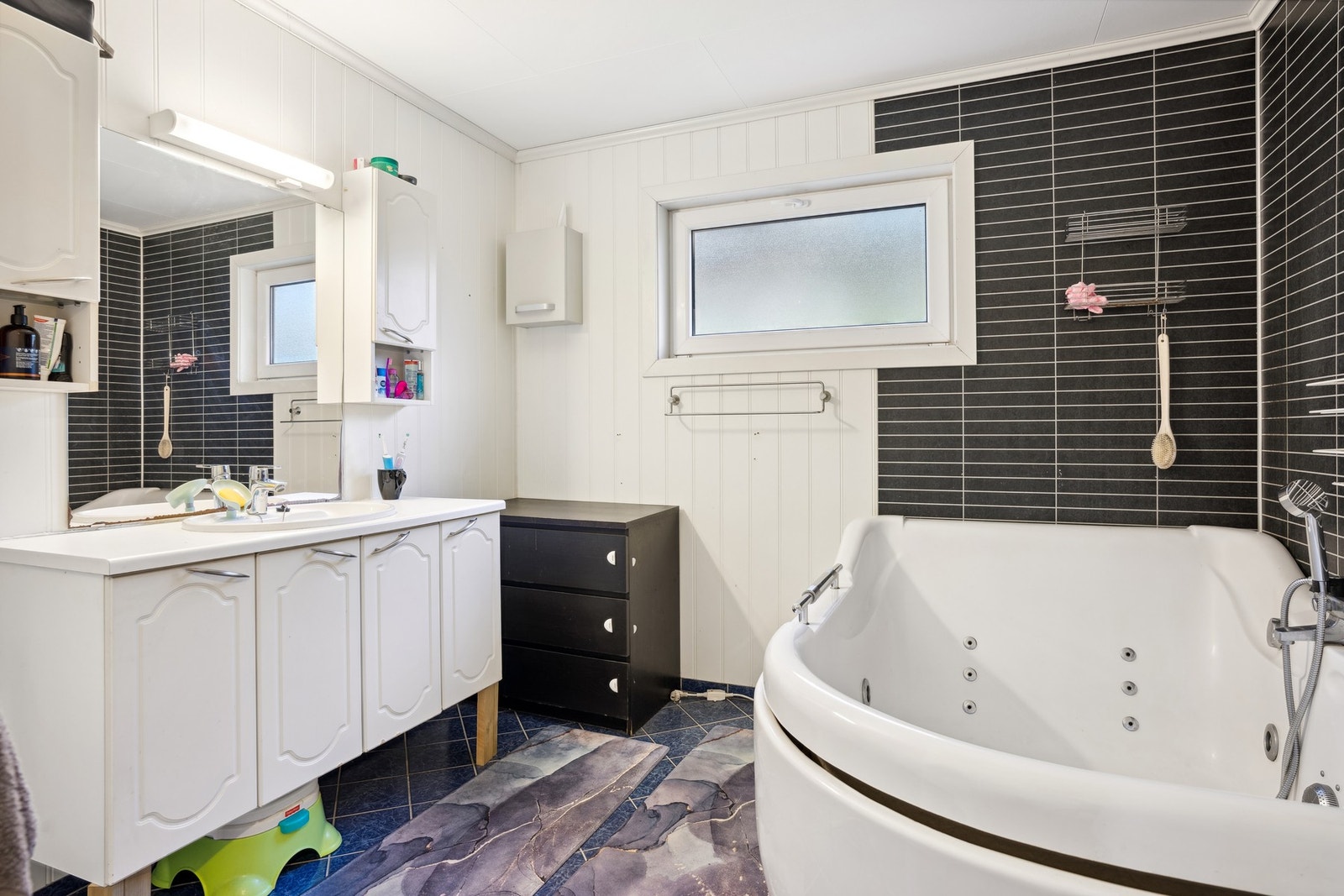 Pent bad med baderomsinnredning, badekar og toalett Galleribilde