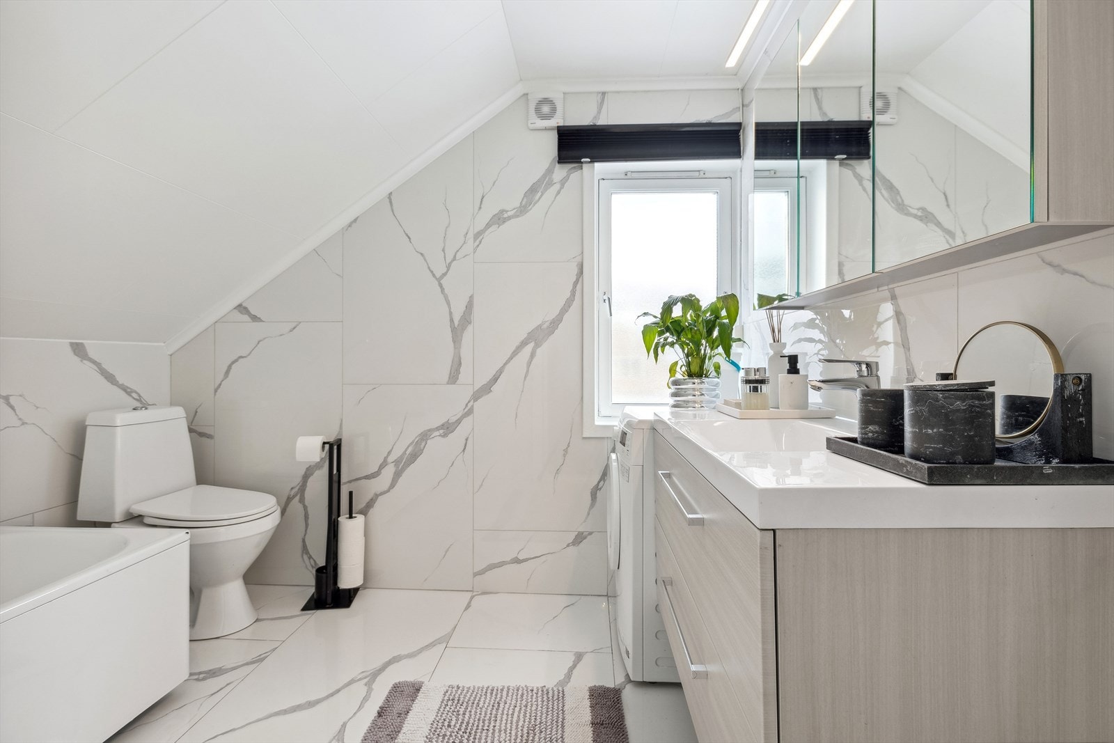 Badet er innredet med nyere baderomsinnredning, badekar og toalett. Galleribilde