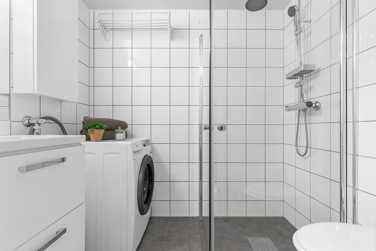 Lyst og romslig baderom med flislagte overflater og underliggende gulvvarme som skaper en komfortabel atmosfære året rundt. Galleribilde