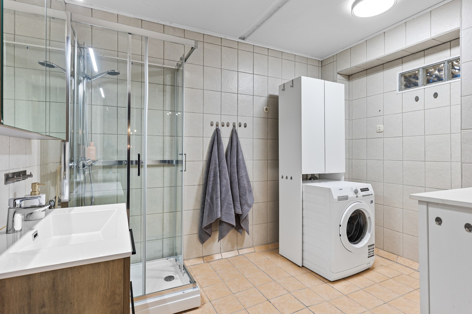 Svært romslig, flislagt bad med opplegg for vaskemaskin. Galleribilde