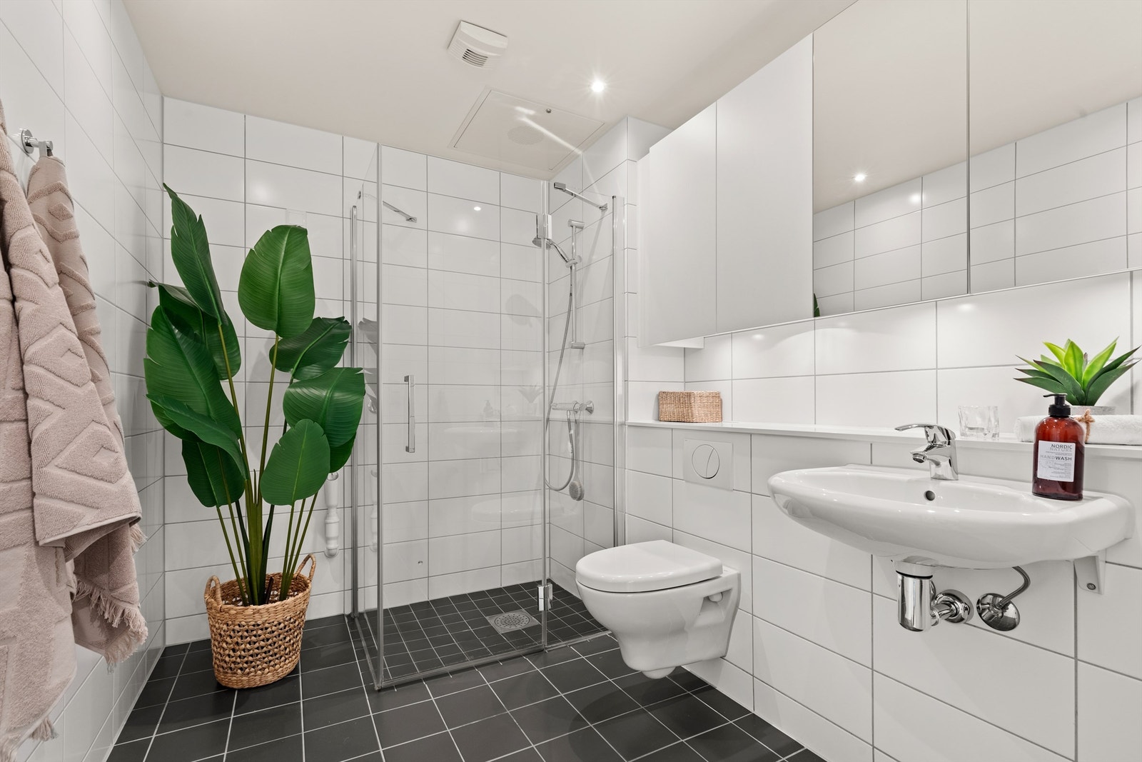 Badet i leiligheten er pent flislagt på gulv og vegger med vannbåren varme i gulvet. Galleribilde