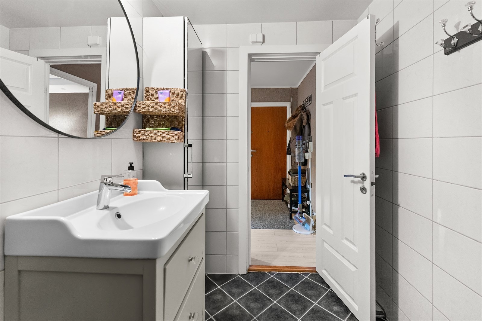 Badet er flislagt med varmekabler i gulvet og har en fin innredning med skuffer og høyskap. Galleribilde