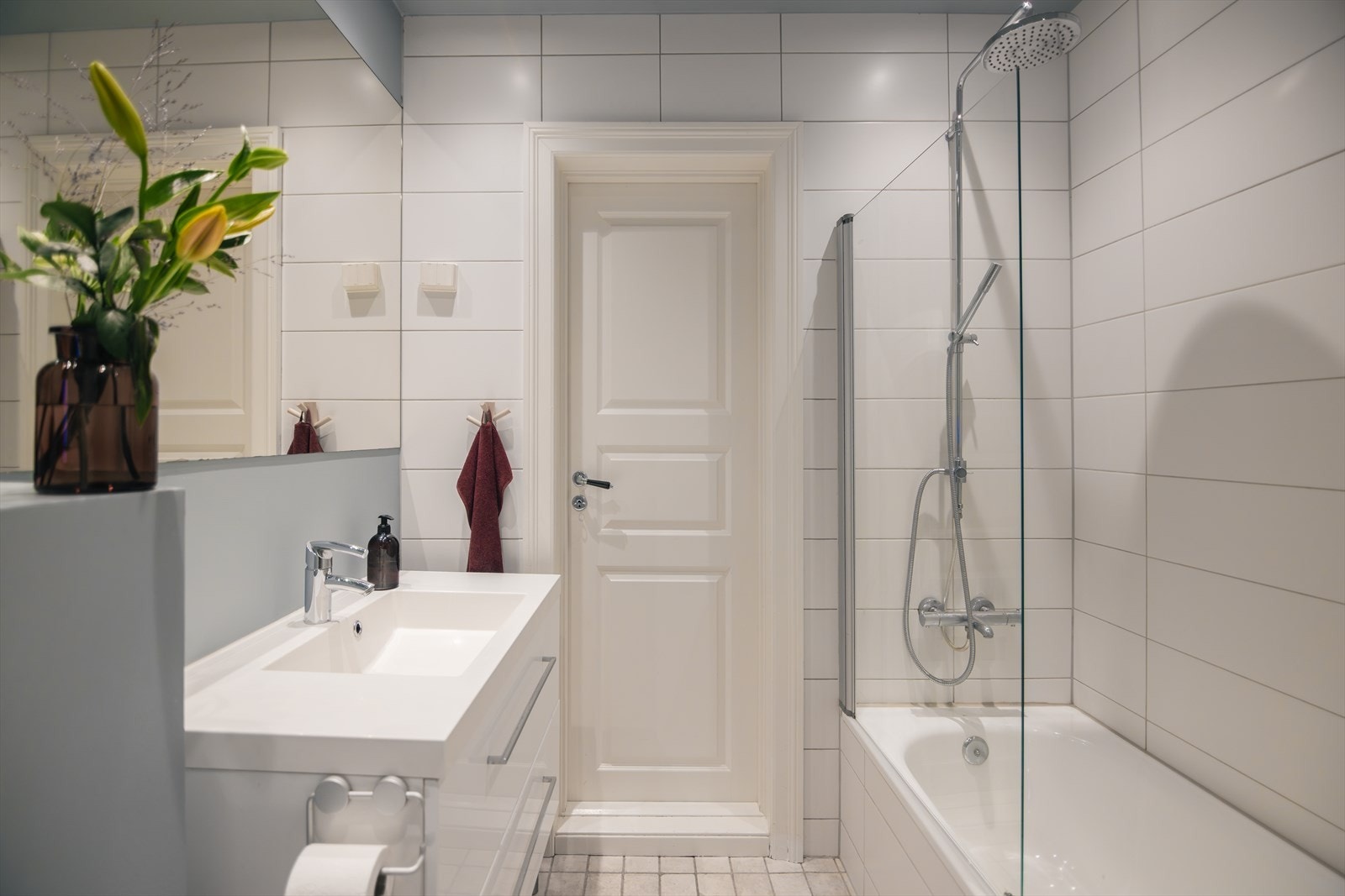 Badet er innredet med vegghengt klosett, servant med møbelinnredning og badekar med dusjløsning. Galleribilde