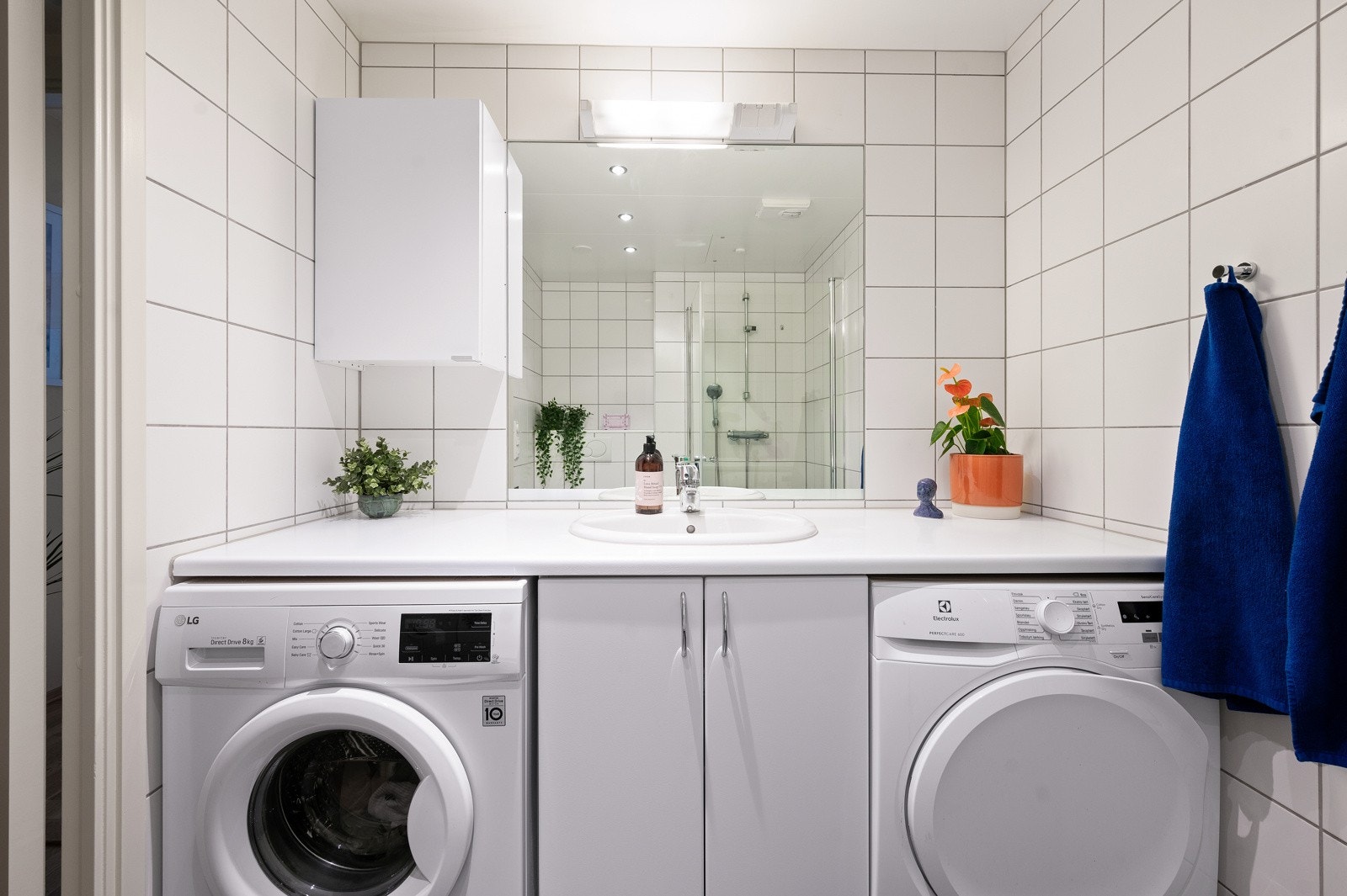 Heldekkende benkeplate med opplegg for både vaskemaskin og tørketrommel under. Galleribilde