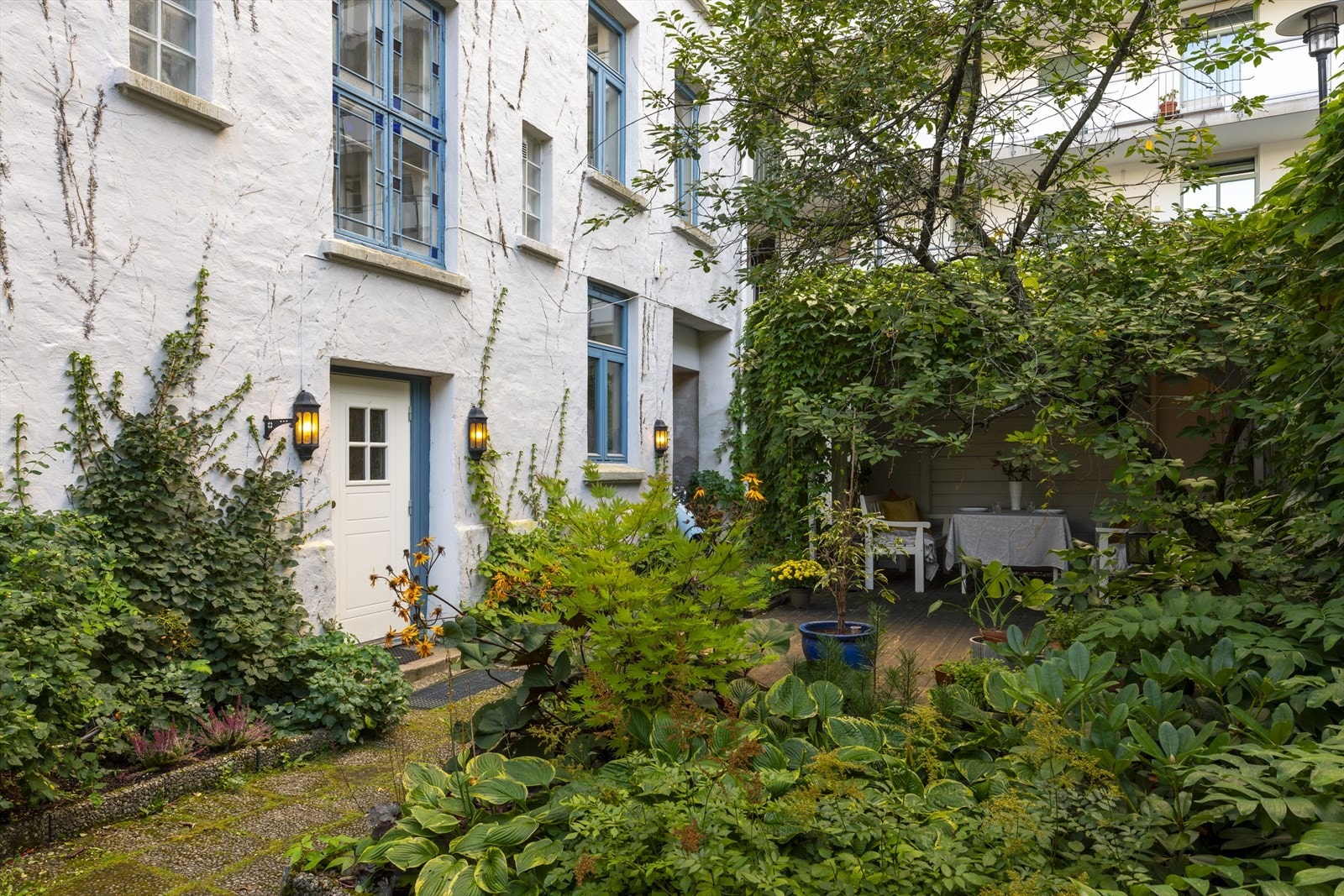 Hyggelig, rolig bakgård med sittegrupper og planter Galleribilde