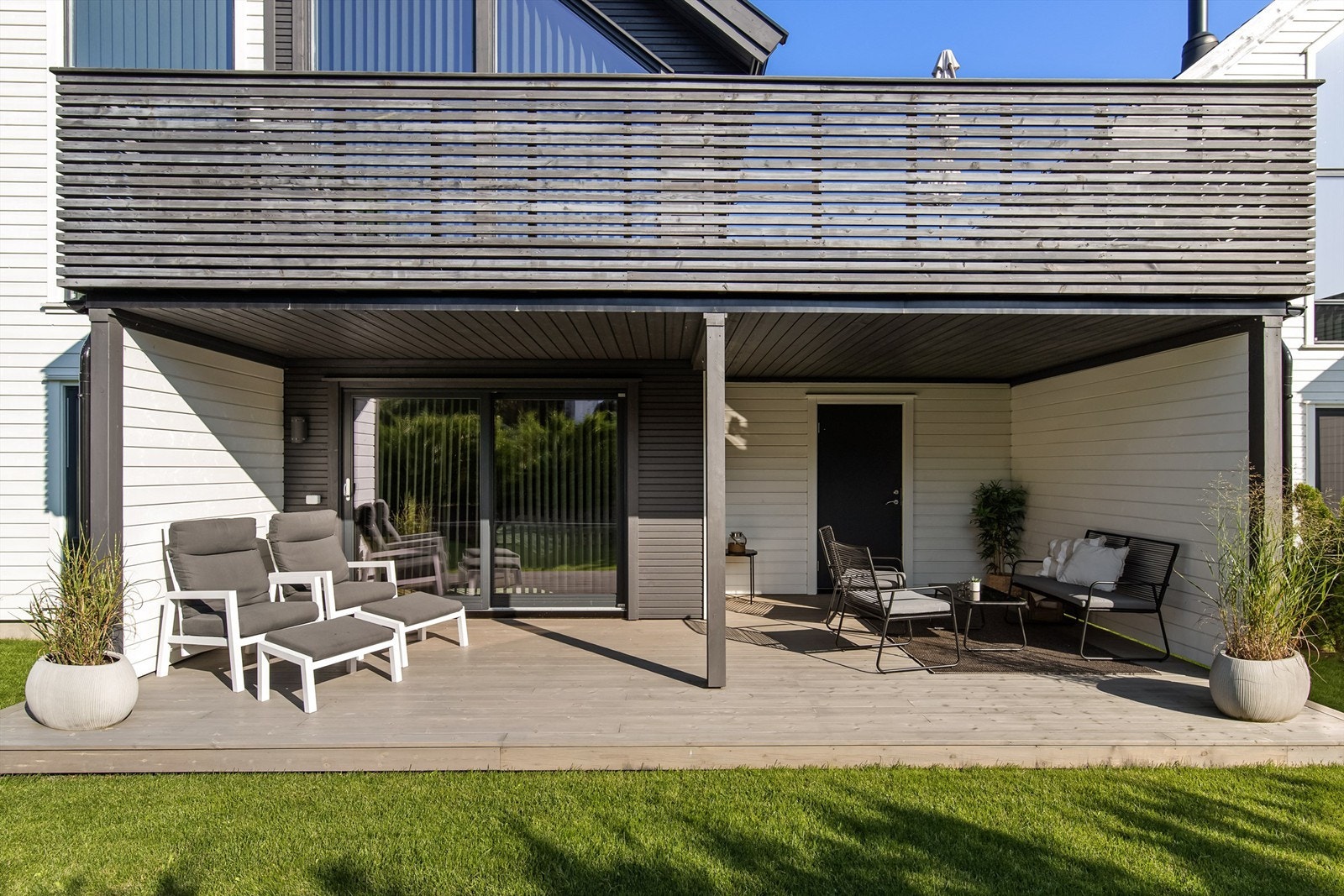 Huset har også en overbygd terrasse i 1.etasje med adkomst til stue/soverom, samt bod/garasje. Galleribilde