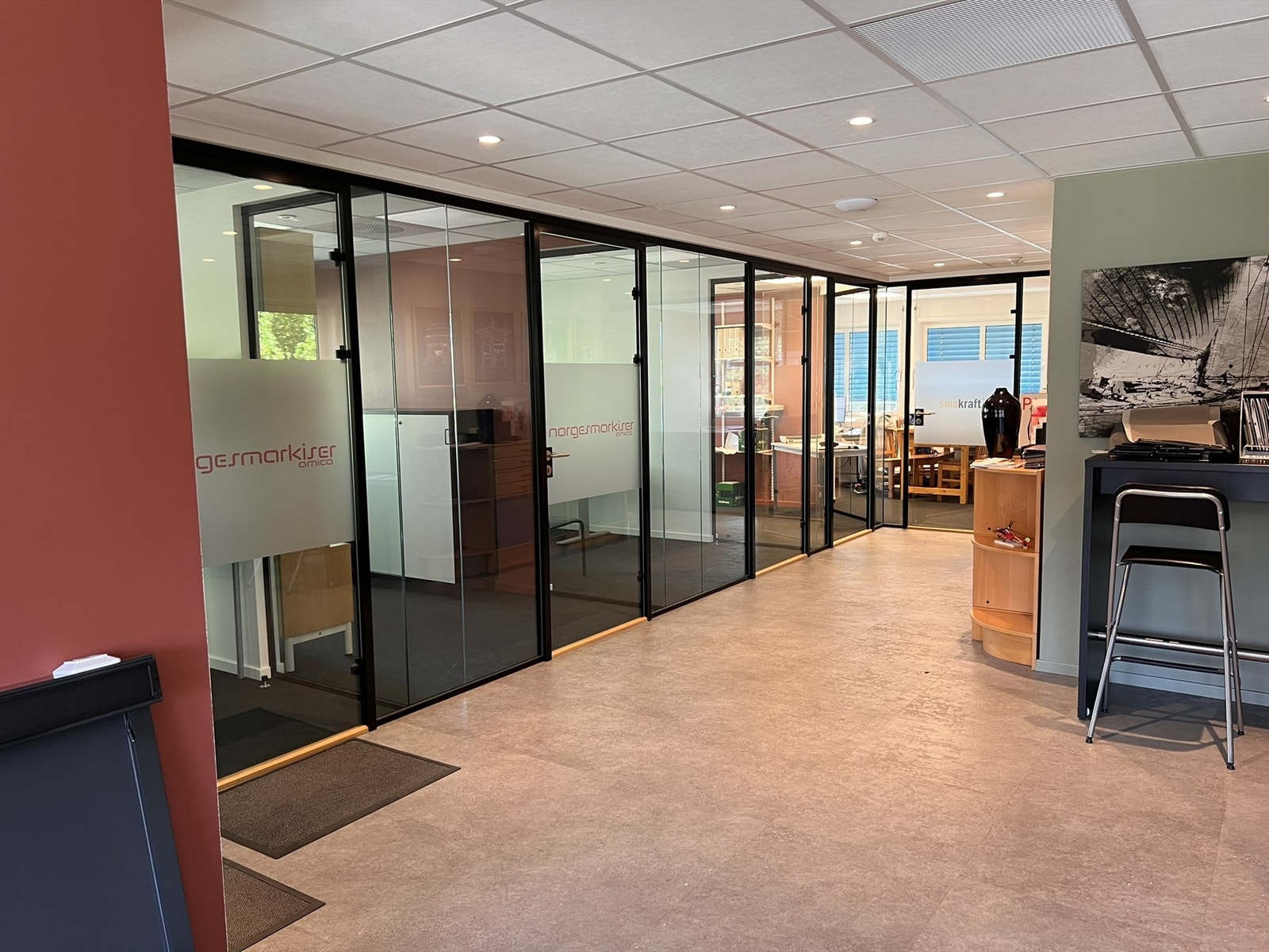 Store åpne fellesarealer med utstrakt bruk av glass mellom kontorer og fellesområder. Galleribilde