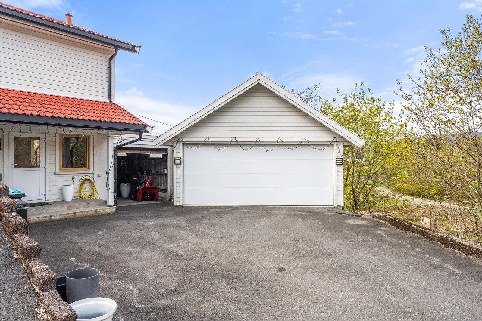 Asfaltert innkjørsel med god plass til parkering. Galleribilde