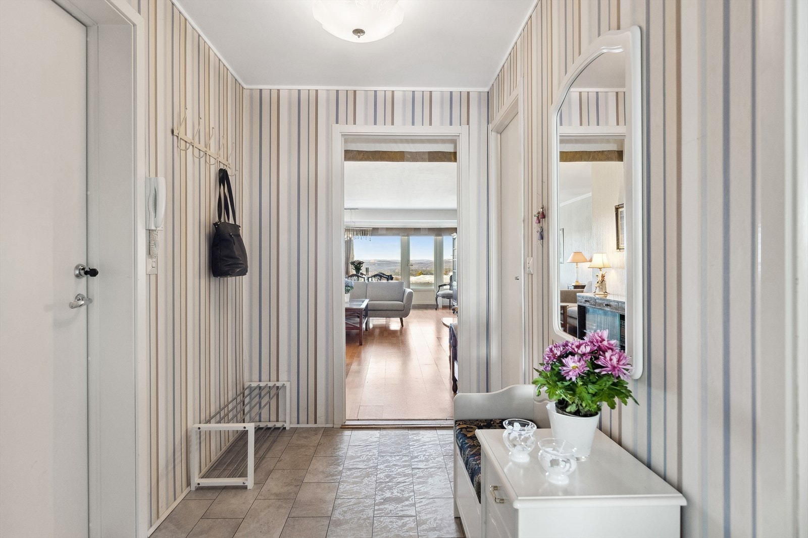 Velkommen inn. Entre/gang med knagger på vegg.
Inngang til stue, kjøkken, toalett og to soverom. Galleribilde