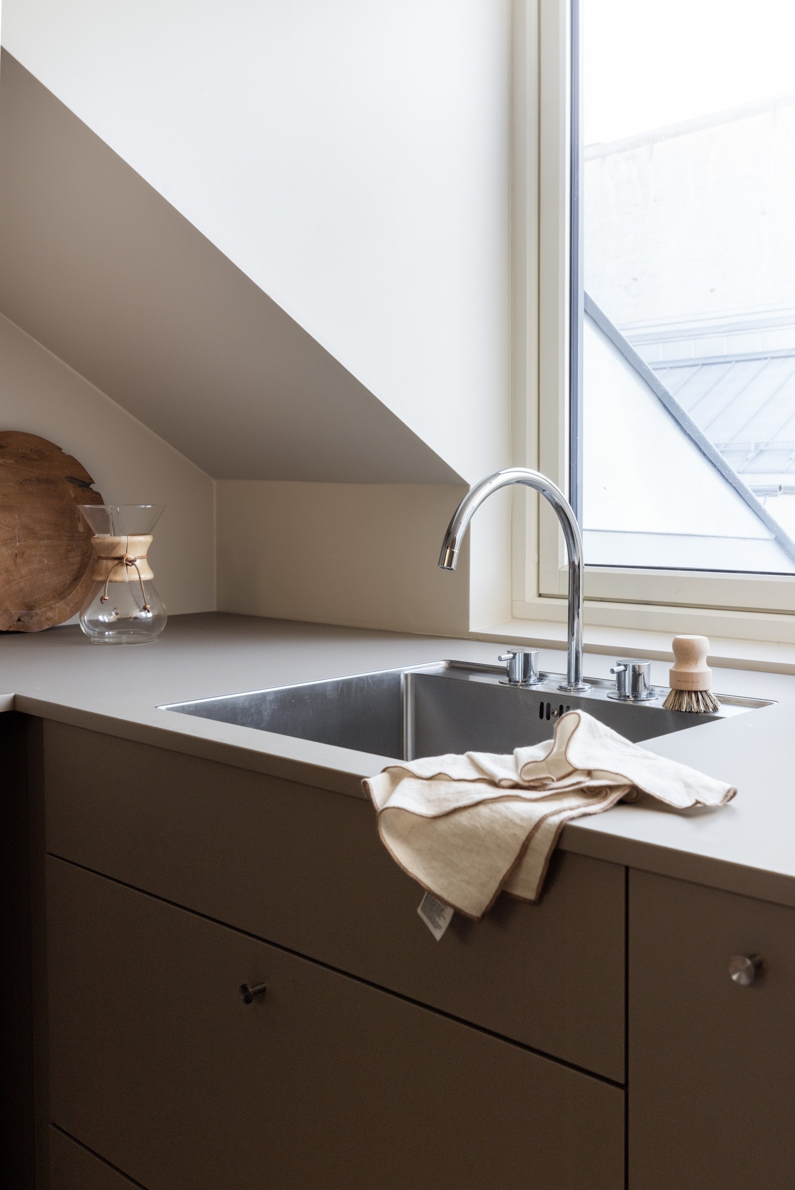 Underlimt vask montert med armatur fra Vola på Kvik touch benkeplate. Galleribilde