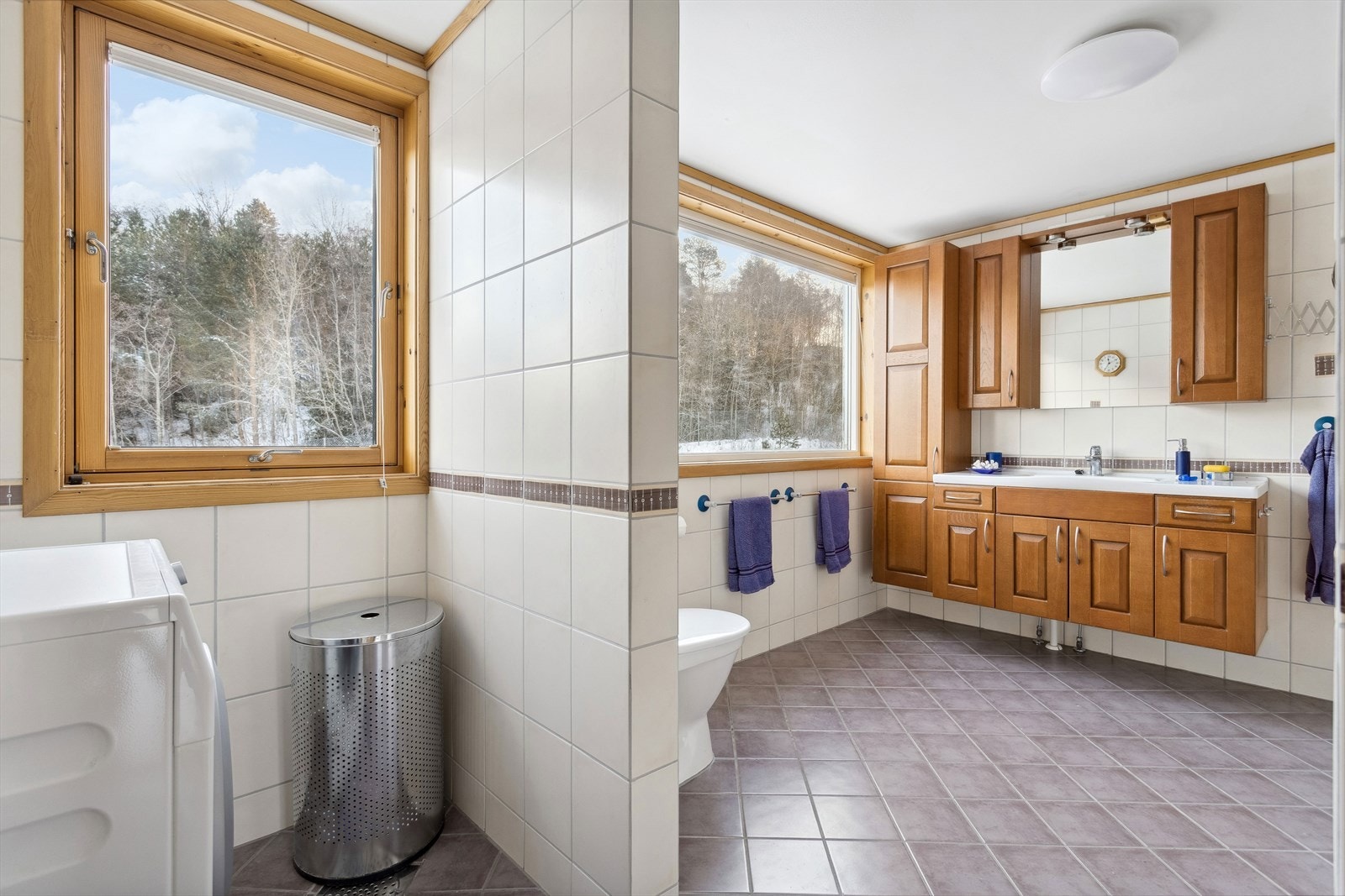 Flislagt baderom på 11 m² utstyrt med servant, servantskap og opplegg for vaskemaskin og wc. Varmekabler i gulv. Galleribilde