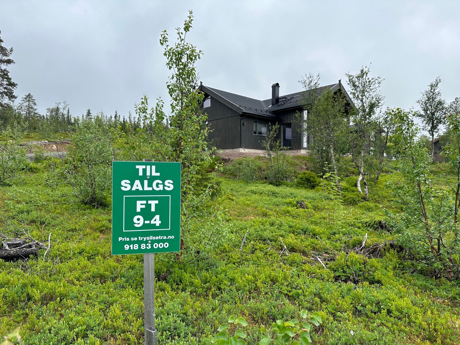 Tomteskilt med en ferdig bygget Solheim 110 på nabotomt Galleribilde