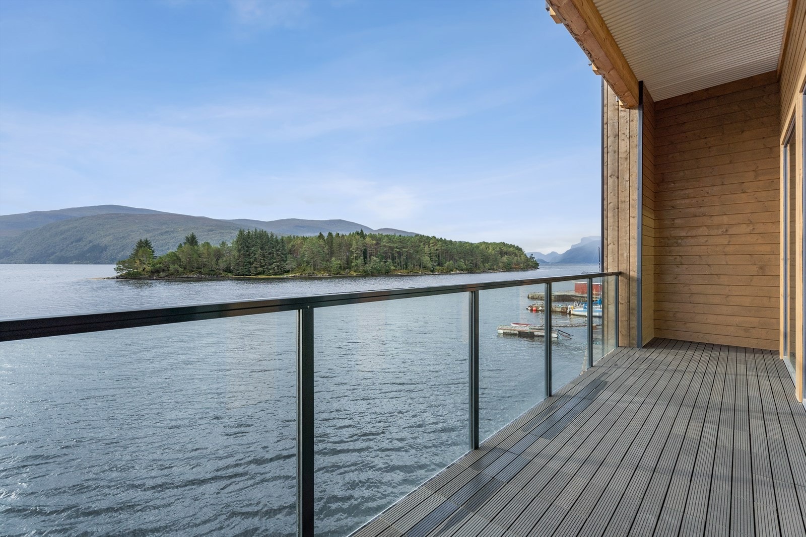 Frå stova har ein utgang til terrasse, og med glasrekkverk får ein eit minimalistisk og stilig uttrykk, samtidig som det sikrar den vakre utsikta. Galleribilde