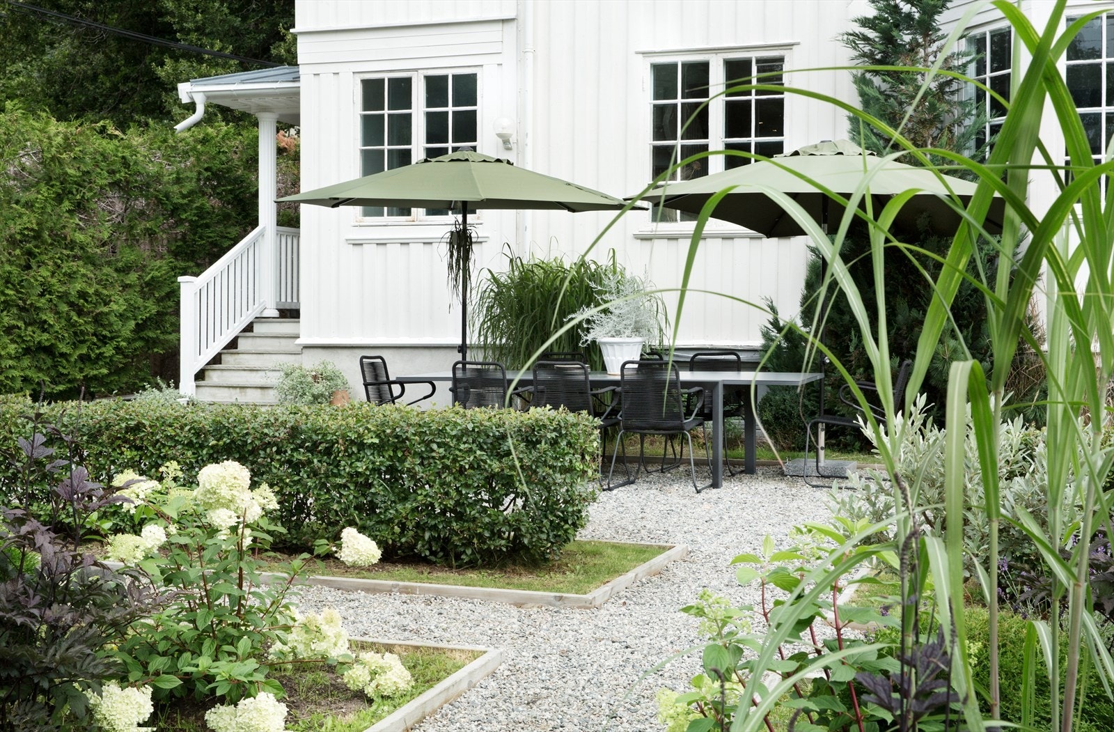 Meget vakkert og parkmessig opparbeidet haveanlegg med frodig beplantning og gruslagte internstier Galleribilde