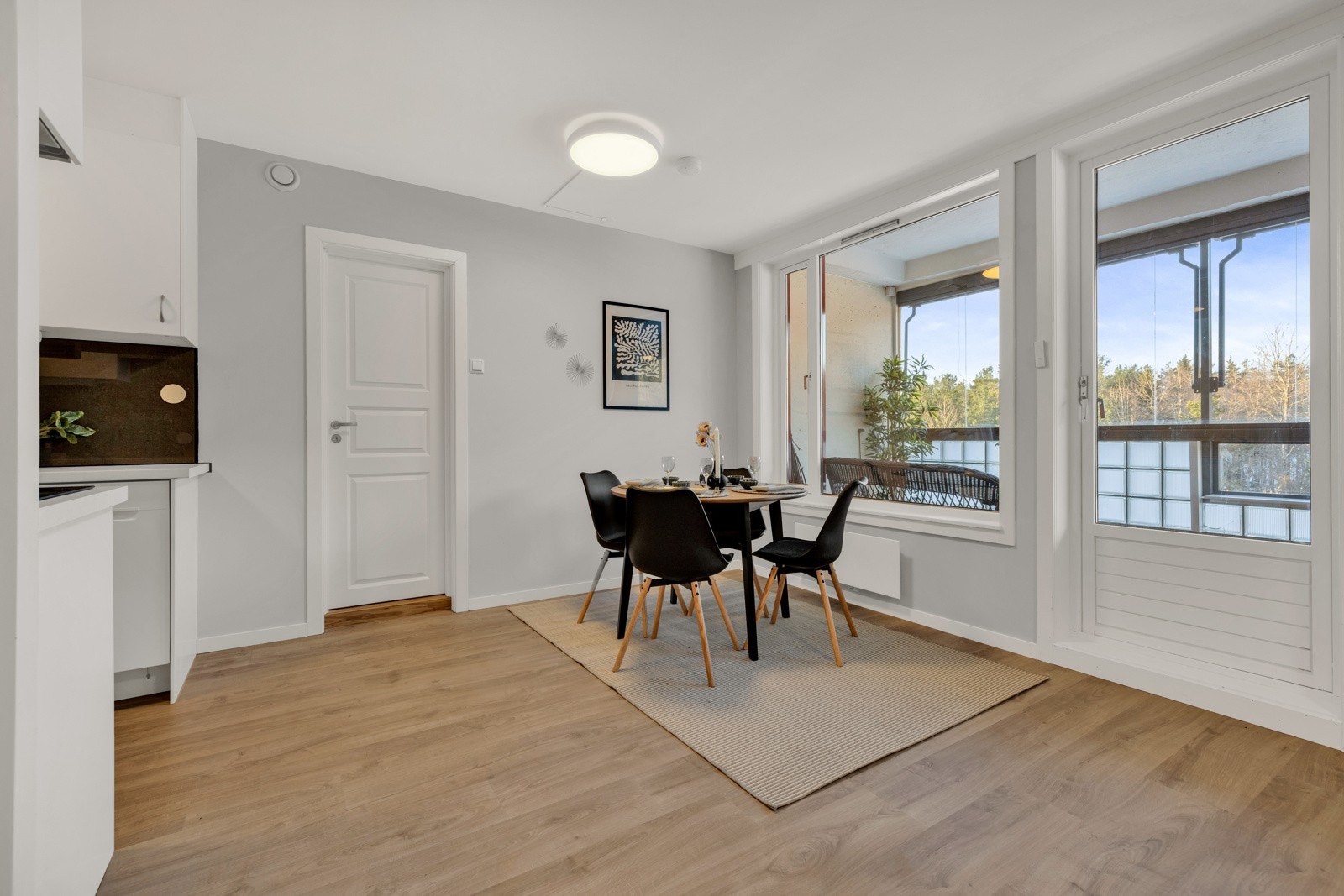 Delvis åpen løsning mellom kjøkken og stue med naturlig plass for spisegruppe. Galleribilde