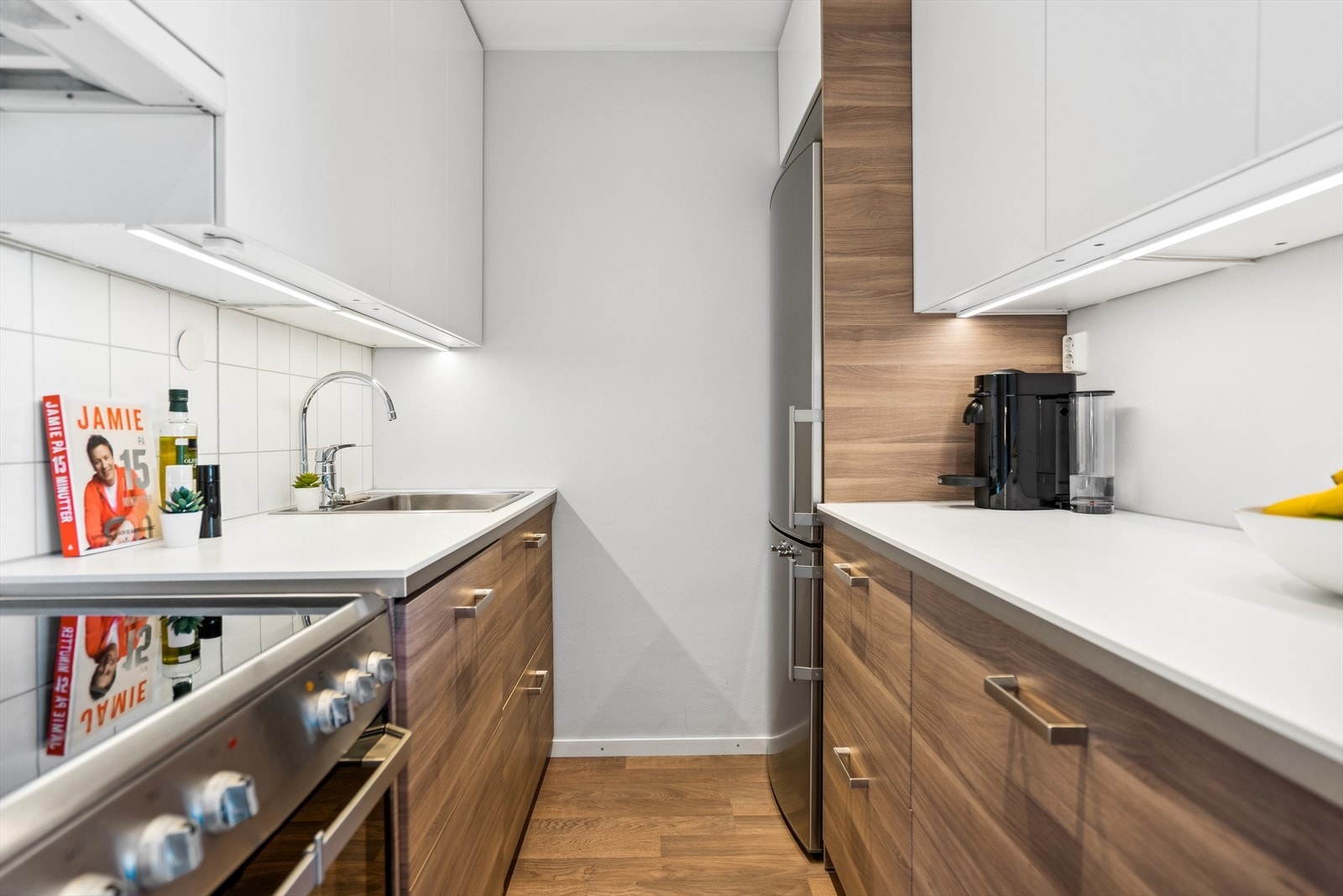 Kjøkkenet er utstyrt med frittstående kjøl/frys, frittstående komfyr med keramisk topp og integrert oppvaskmaskin. Alle hvitevarer medfølger salget. Galleribilde