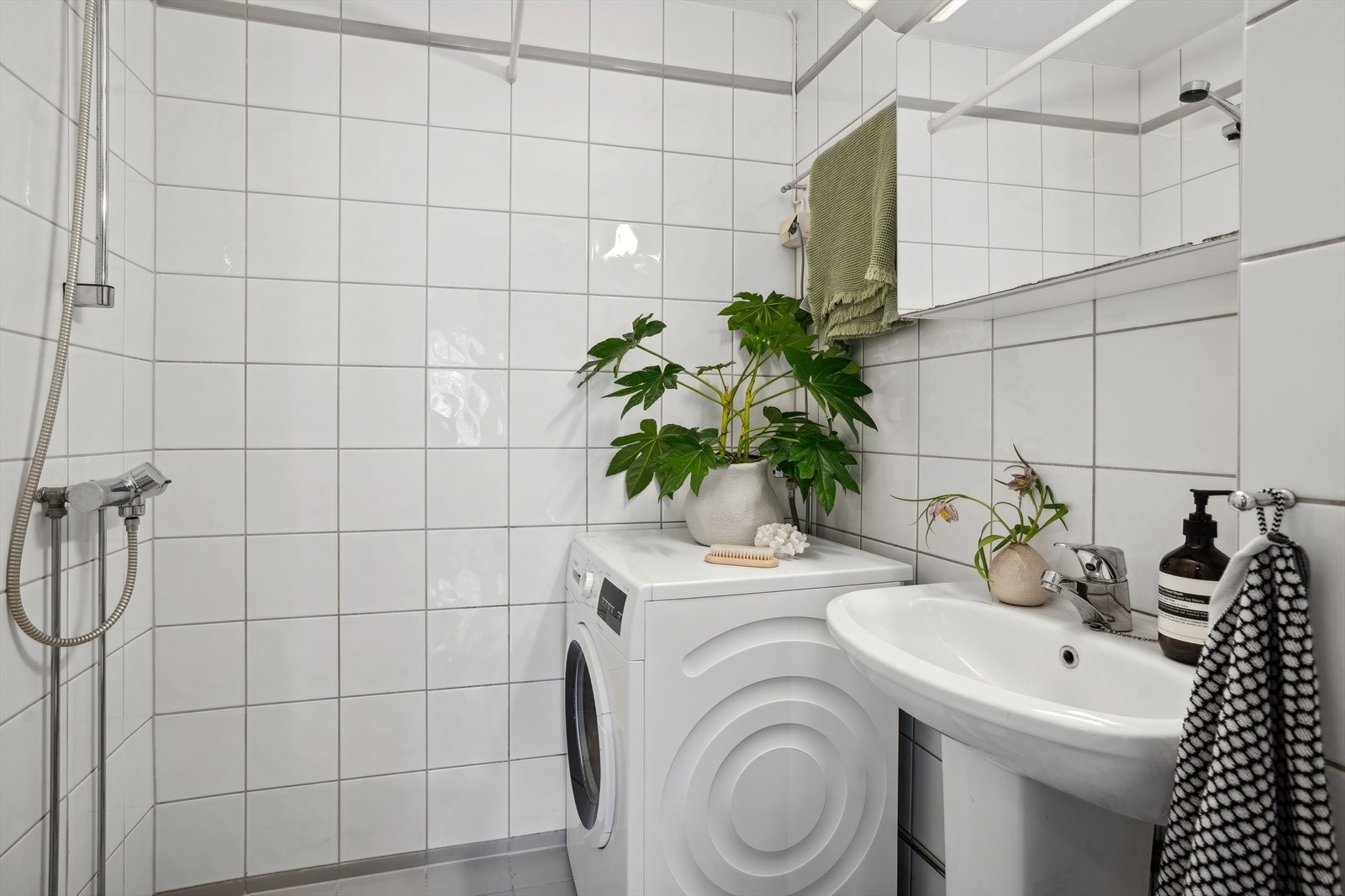 Badet har fliser på gulv og vegger, standard innredning, gulvvarme og dusjhjørne. Galleribilde
