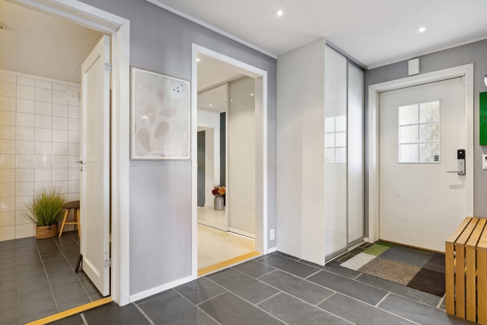Man ønskes velkommen av en innbydende gang med downlights og skyvedørsgarderobe. Galleribilde