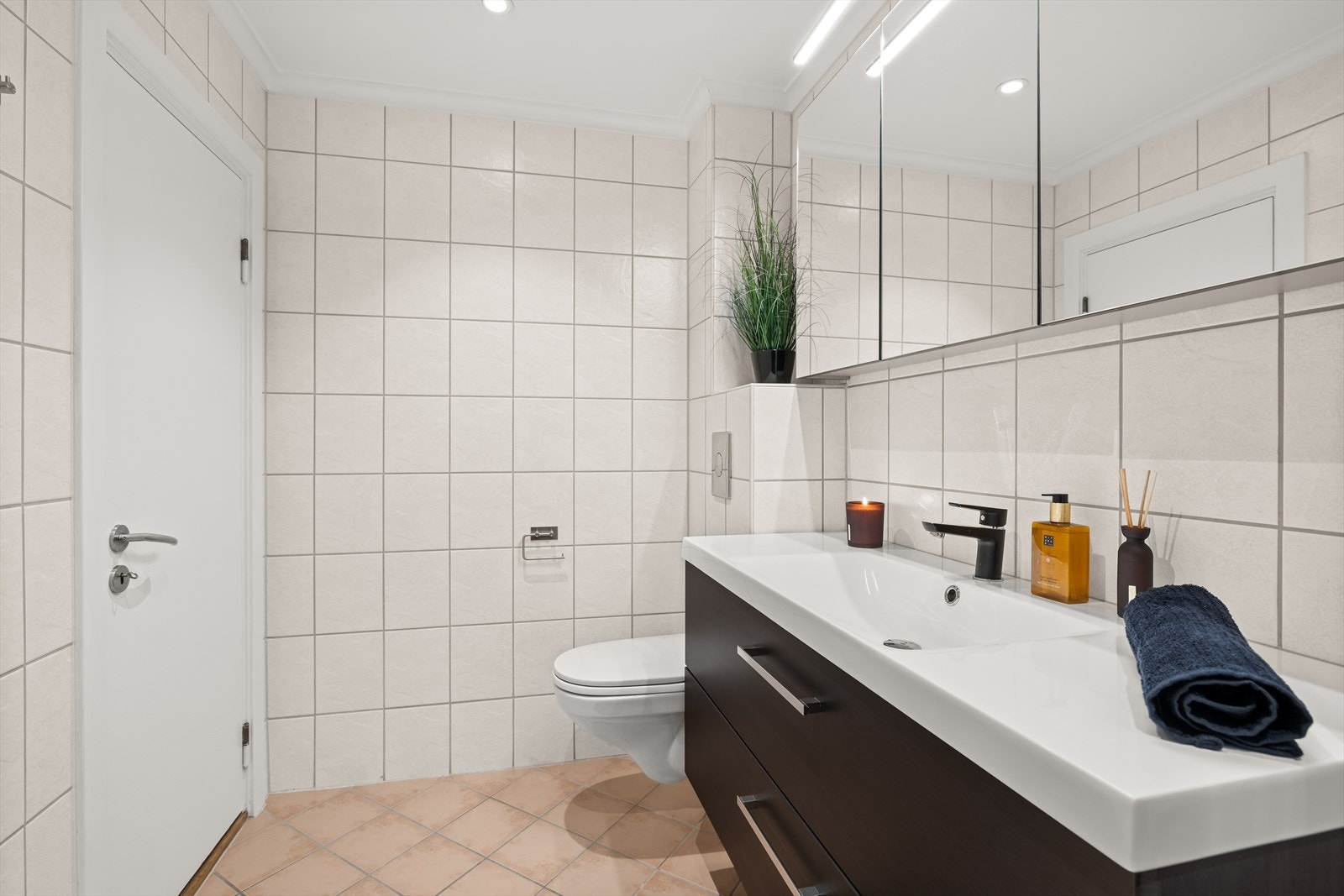 Badet har varme i gulv og plass for vaskemaskin Galleribilde