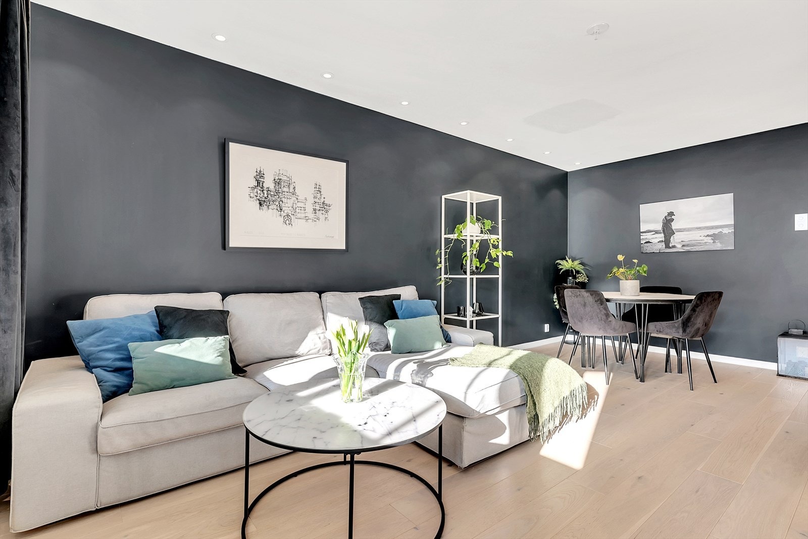 Stue med parkett på gulv, malte slette vegger og malt tak med downlights. Stuen er romslig med god plass til sofagruppe og spisegruppe. Galleribilde