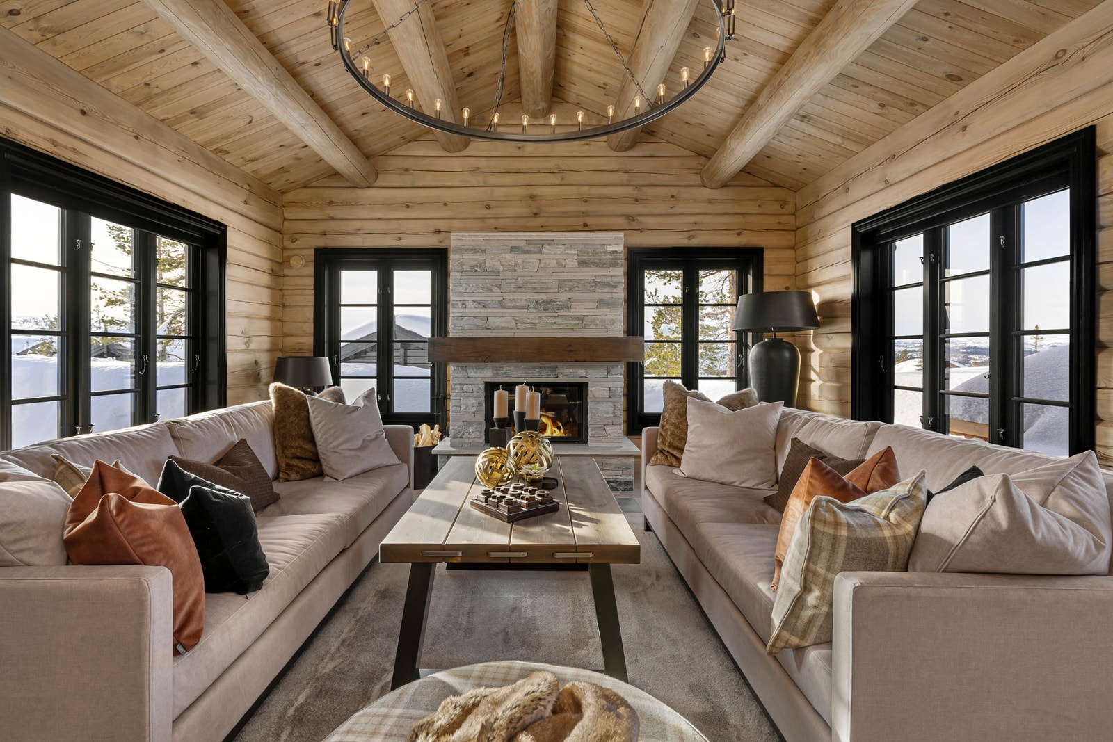 Stue med panoramavinduer og skiferpeis – utsikten er med på laget. Galleribilde