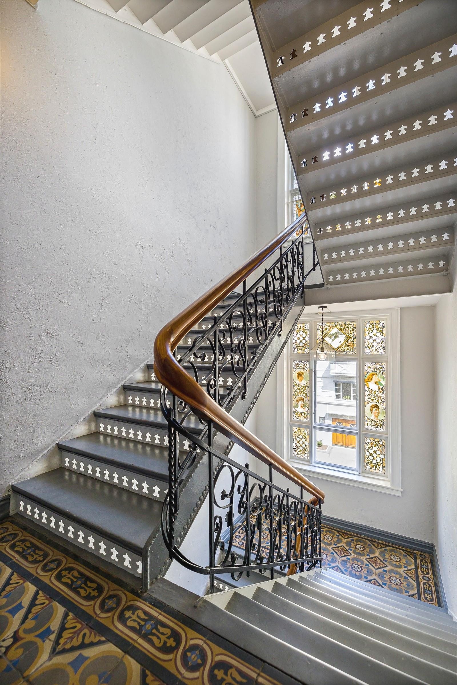 Pen trappeoppgang med belysning og store, mønstrete vinduer Galleribilde