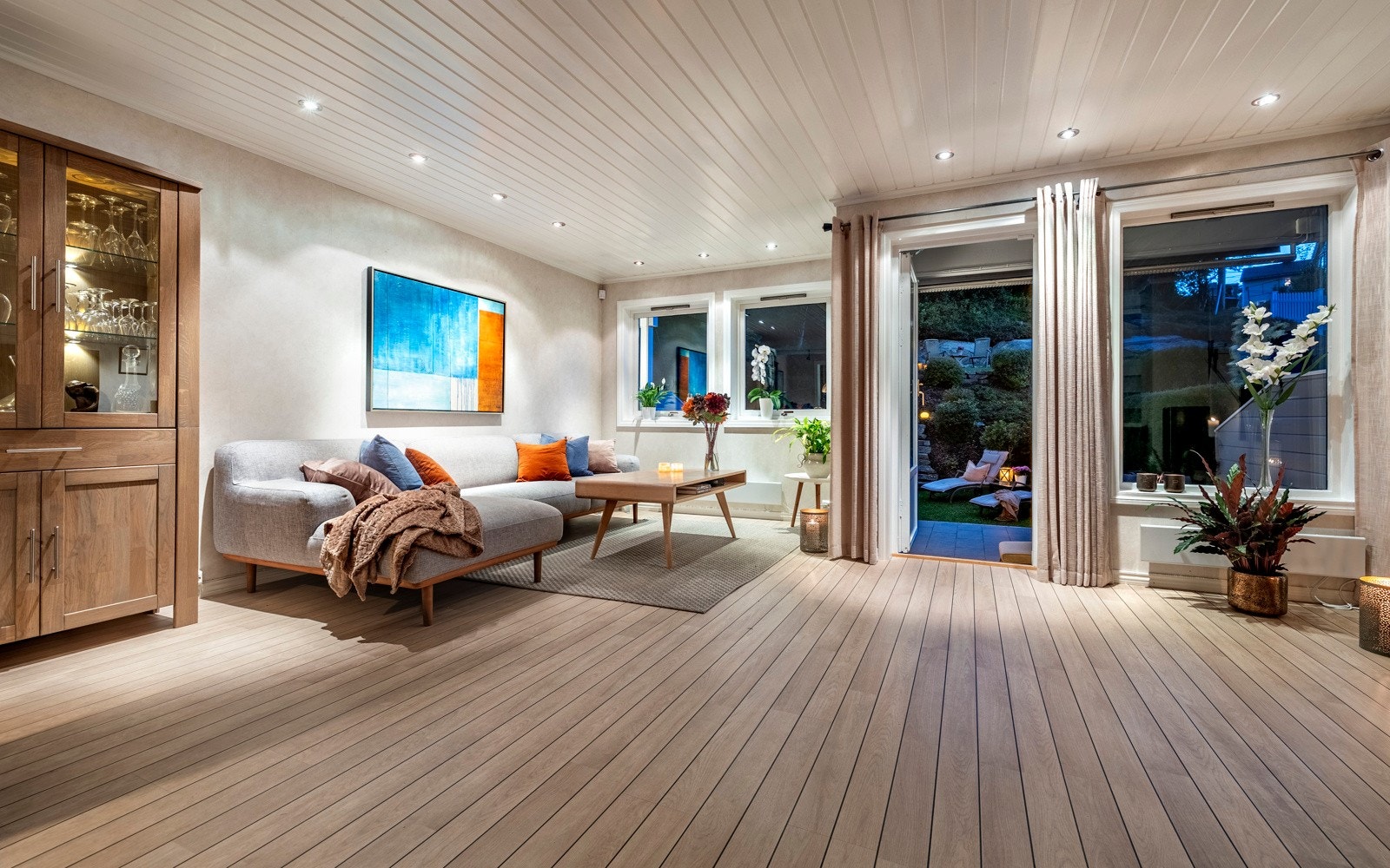 Dagslyset strømmer inn via store, sydvestvendte vinduer i stuen i 1. etasje. Galleribilde