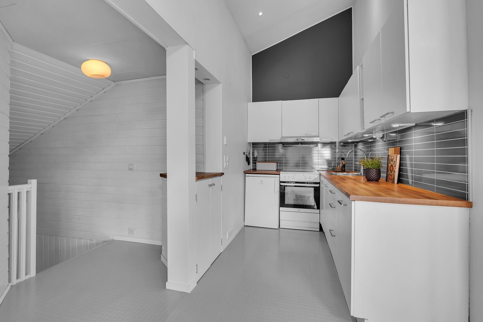 Fra gangen kommer man opp til kjøkkenet som ligger delvis adskilt fra stuen Galleribilde