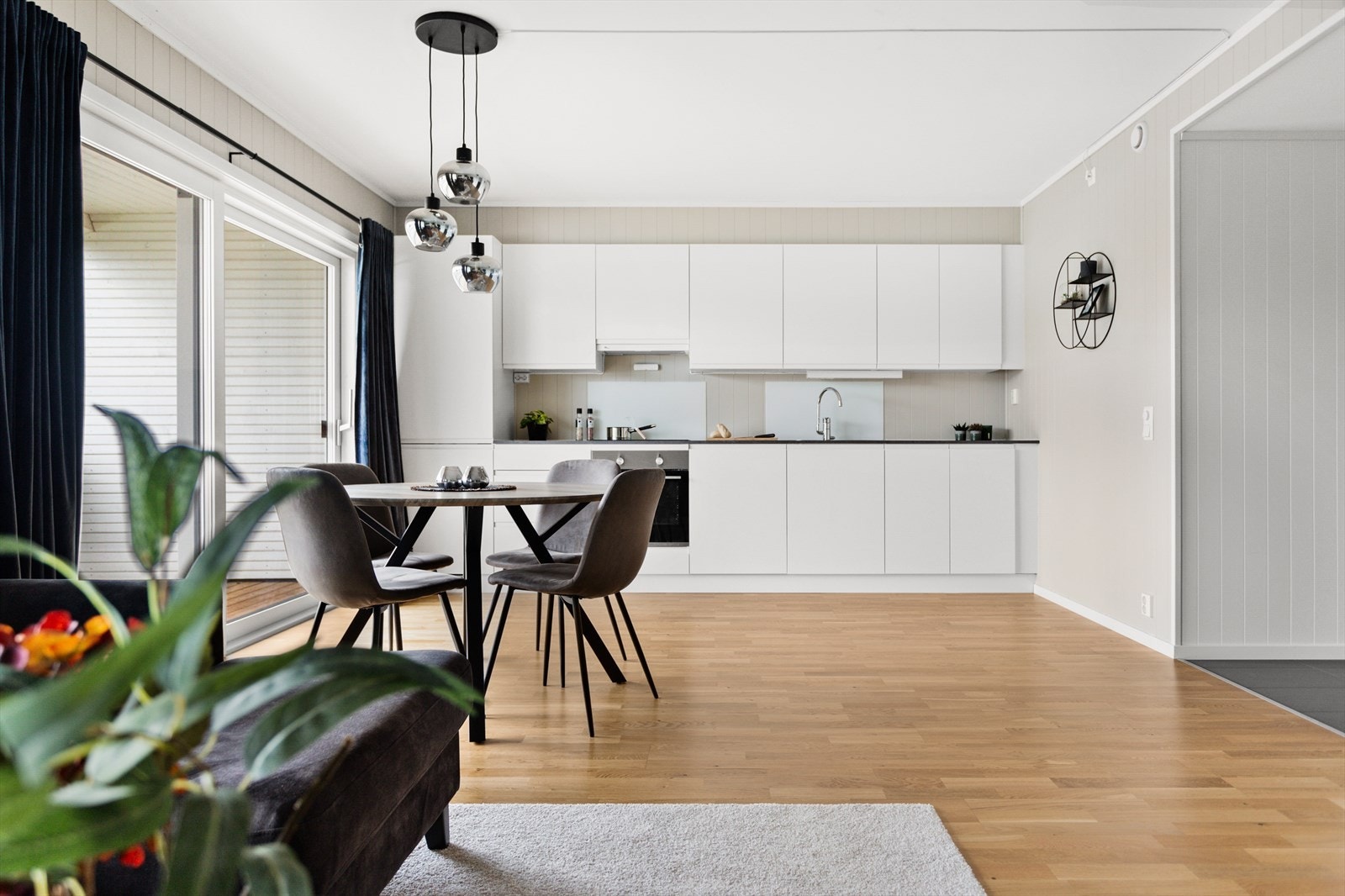 Kjøkkenet har en tidløs innredning med hvite glatte fronter og en benkeplate i laminat. Galleribilde