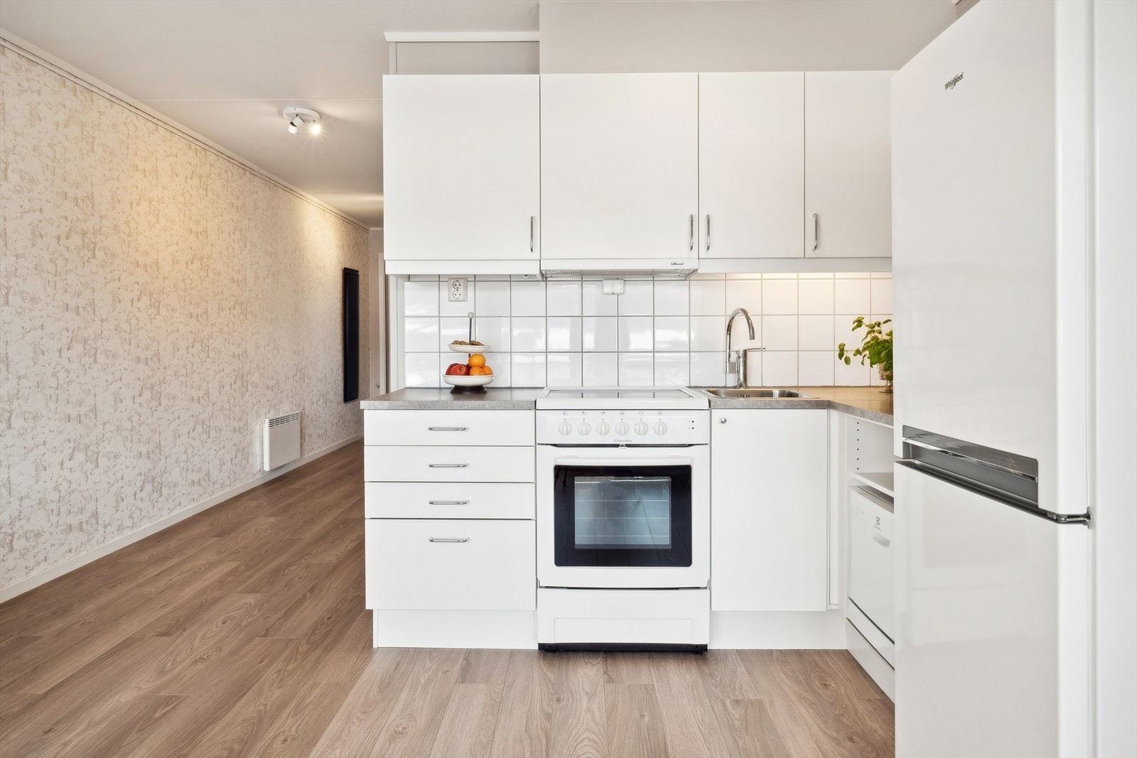 Over benkeplaten er det hvite fliser og belysning som gjør rengjøringen enklere. Galleribilde