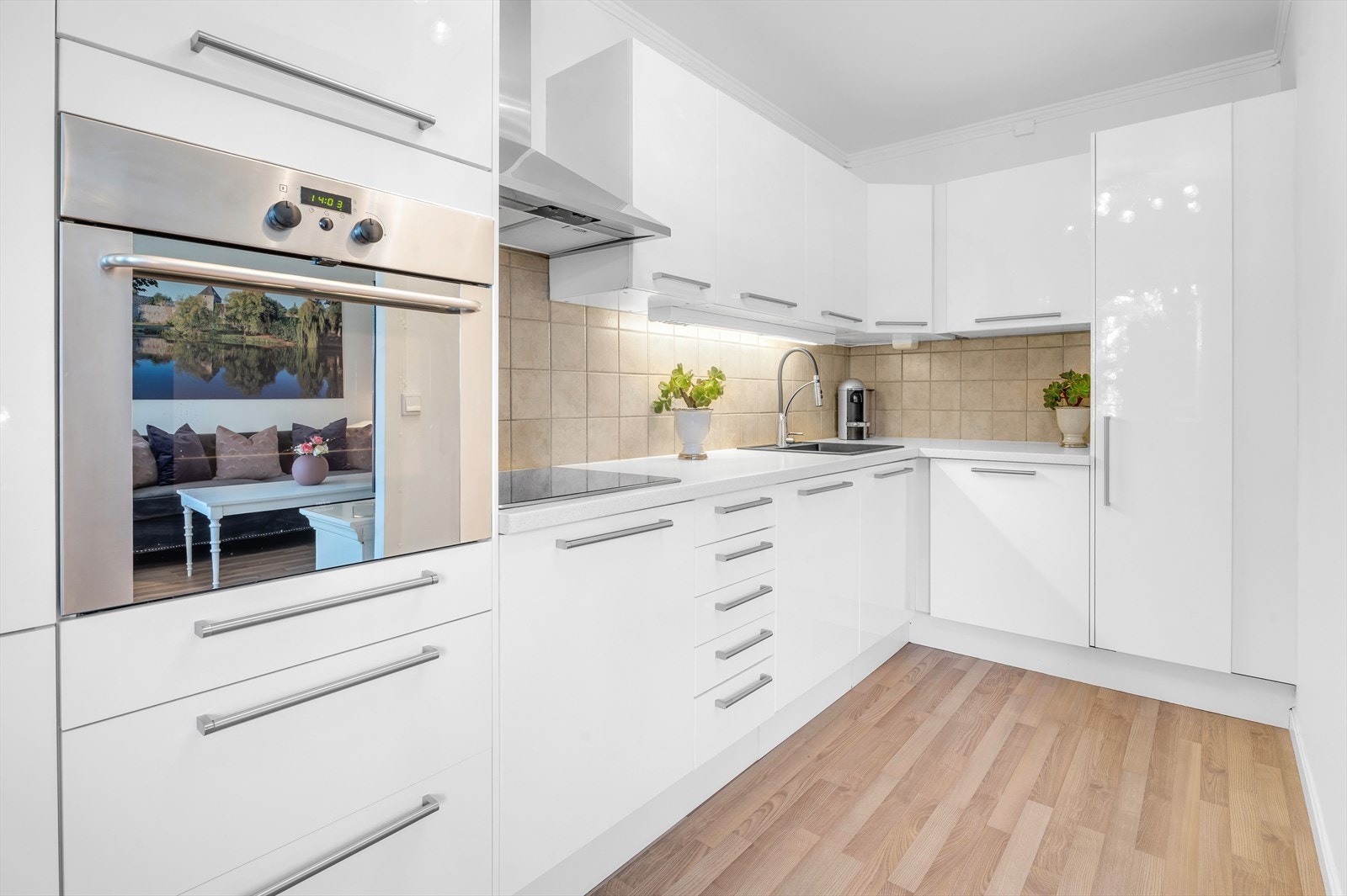 Stilrent kjøkken med integrerte hvitevarer som oppvaskmaskin, stekeovn, koketopp og kjøl/frys
. Galleribilde