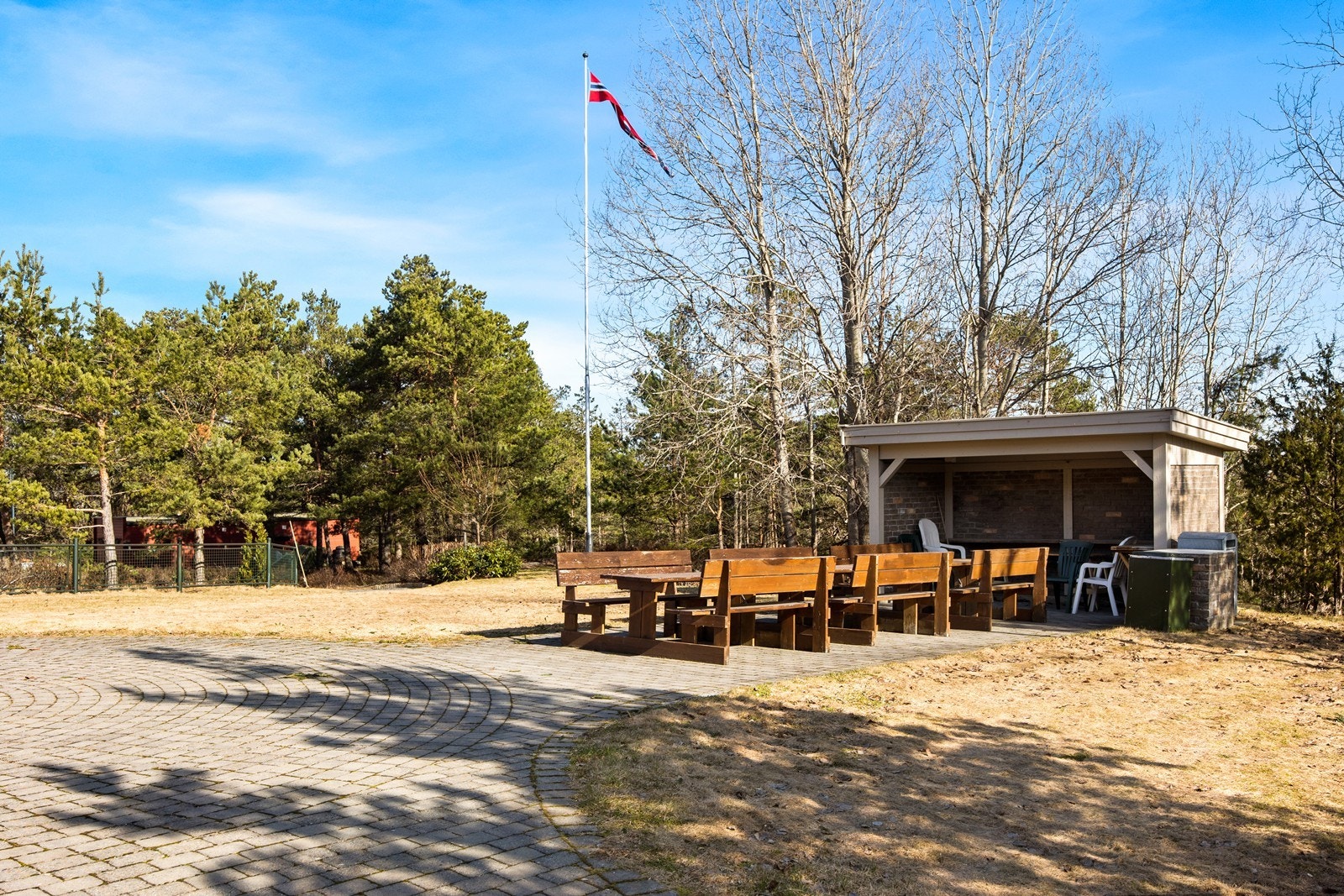 Borettslagets tomt er pent opparbeidet med bl.a. gress, beplantning, belegningsstein, sittegrupper og lekeplass. Galleribilde