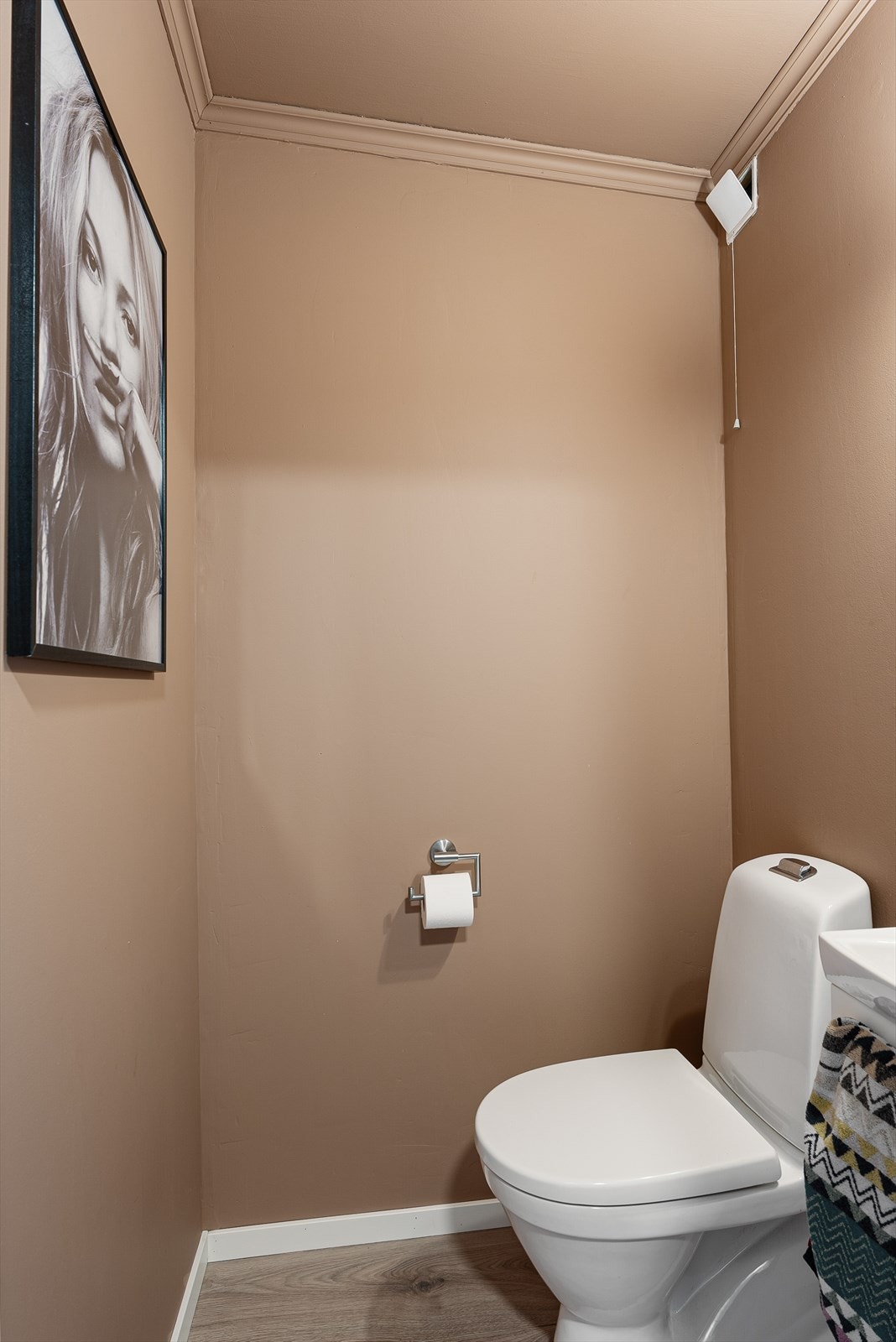 Separat WC som inneholder toalett og innredning med vask og speil Galleribilde