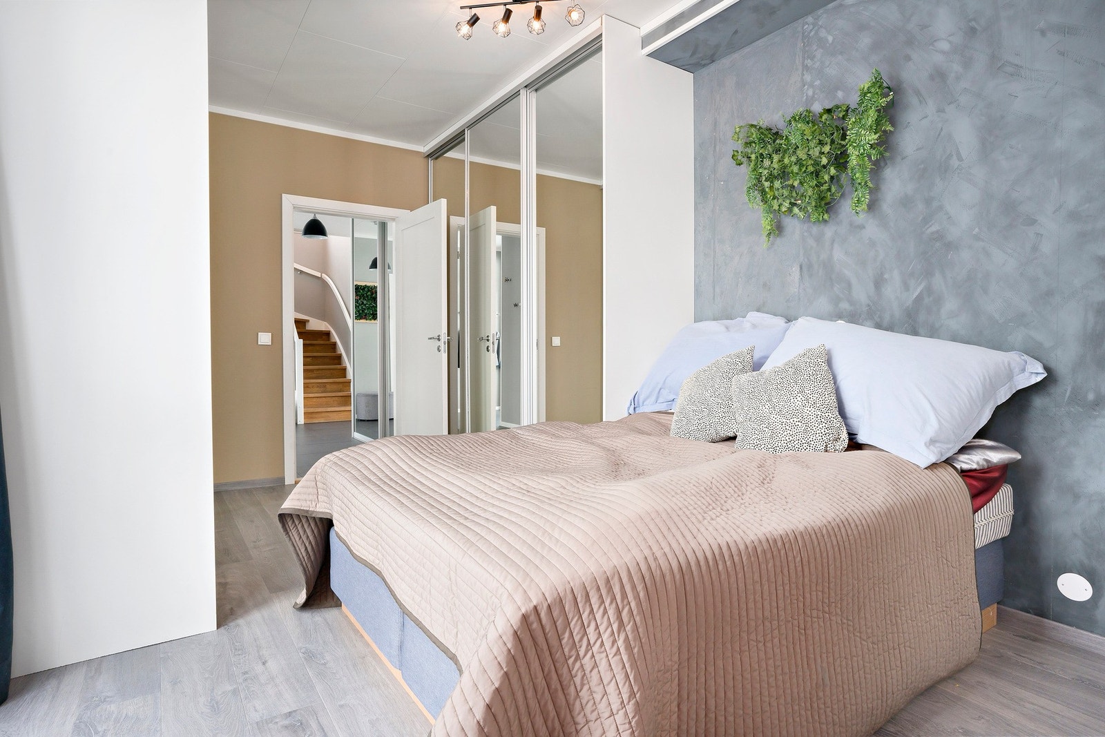 Hovedsoverommet har nesten fem meter skyvedørsgarderobe fra gulv til tak, i tillegg skyvedør med speil inn til eget garderoberom. Videre direkte adgang til eget bad via dør med frostet glass. Galleribilde