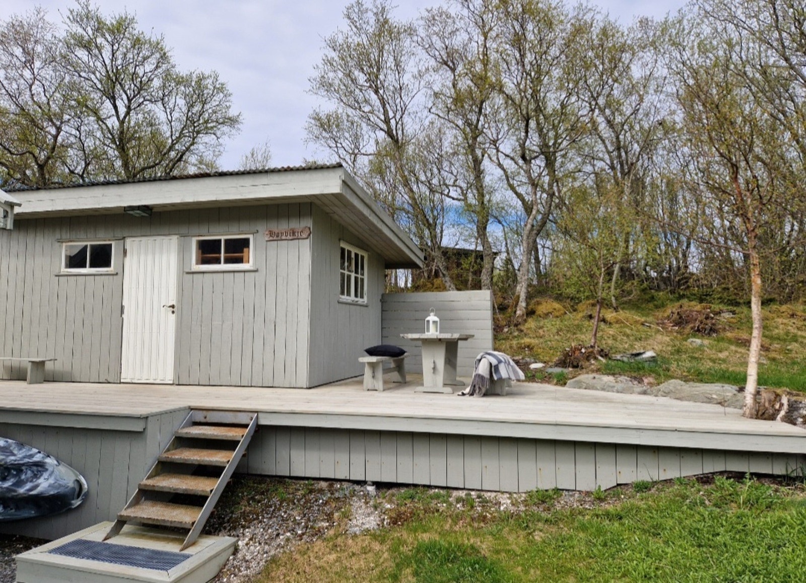 På baksiden får du et uthus på ca. 14m² med platting rundt, som tilbyr en lun sitteplass utendørs Galleribilde